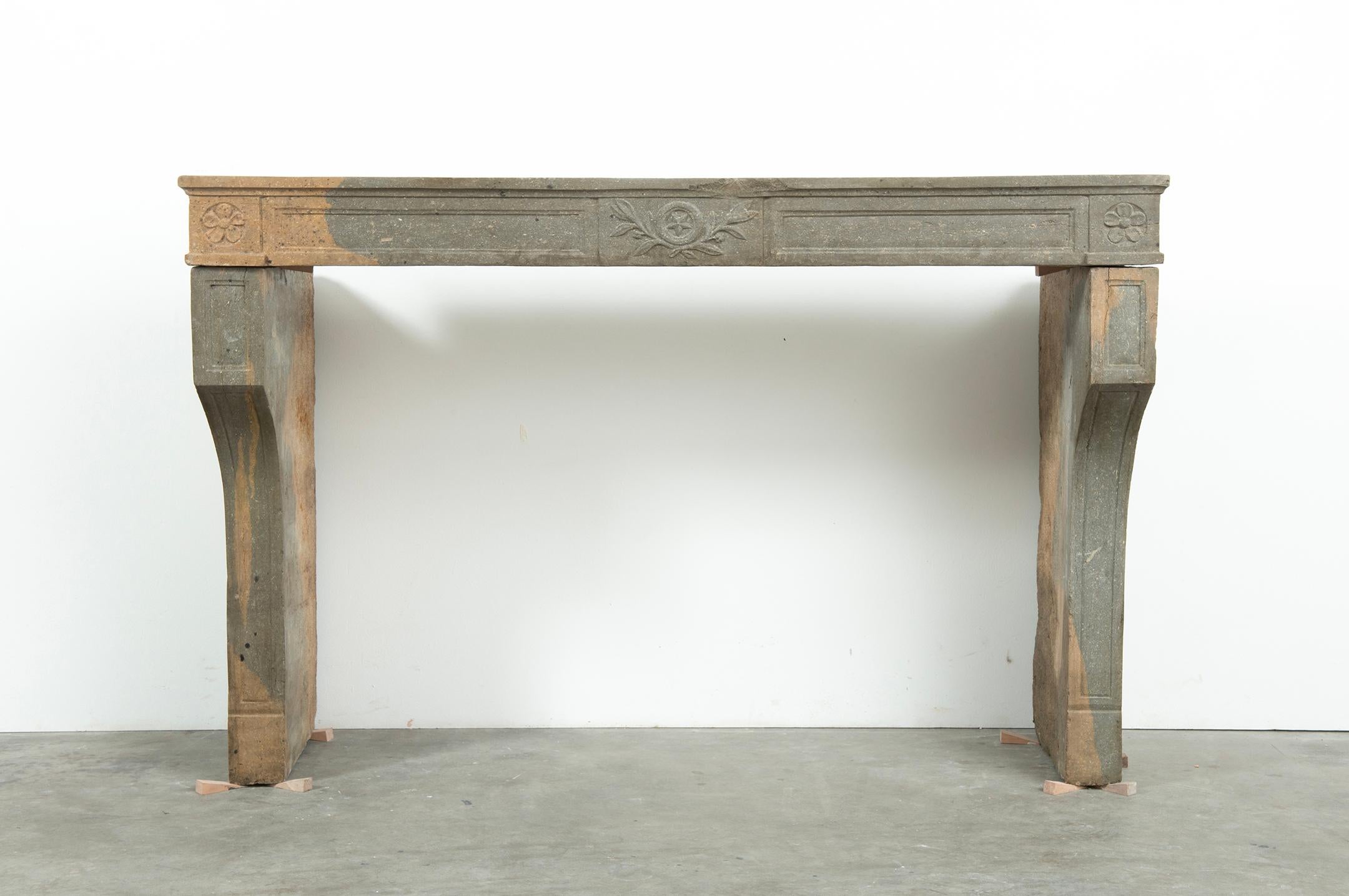 Very happy to offer this bi-color French Louis XVI Fireplace Mantel.

Coming from the Burgundy area this warm colored limestone fireplace is unrestored and still has its original patina.
The decorations, curved legs combined with the straight frieze
