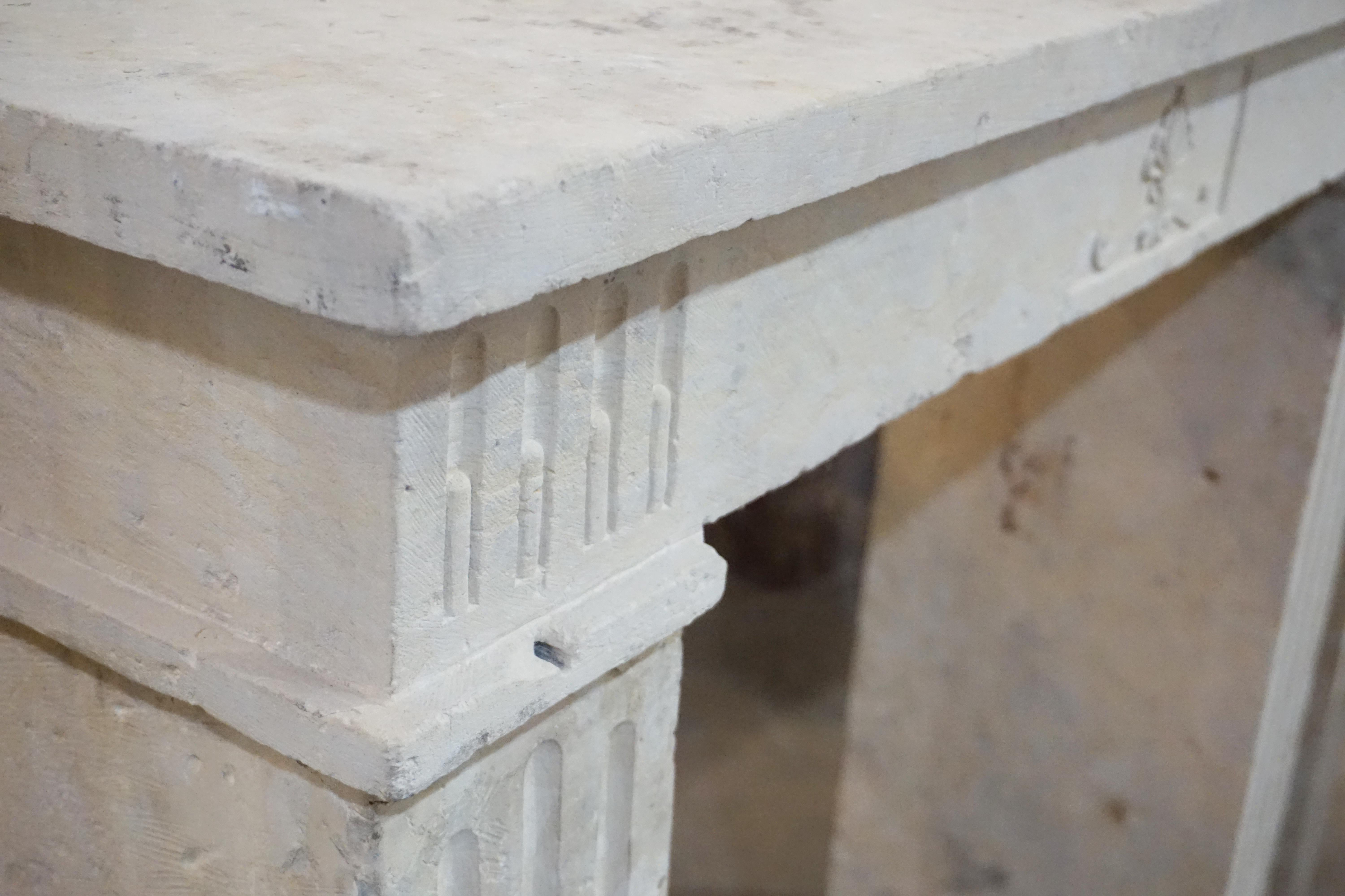 This 18th century limestone mantel features detailed carved design in the centre it's face, as well as along each leg. 

Measurements: 46'' W x 46.5'' H x 13.5'' D
Firebox: 32'' W x 40'' H.