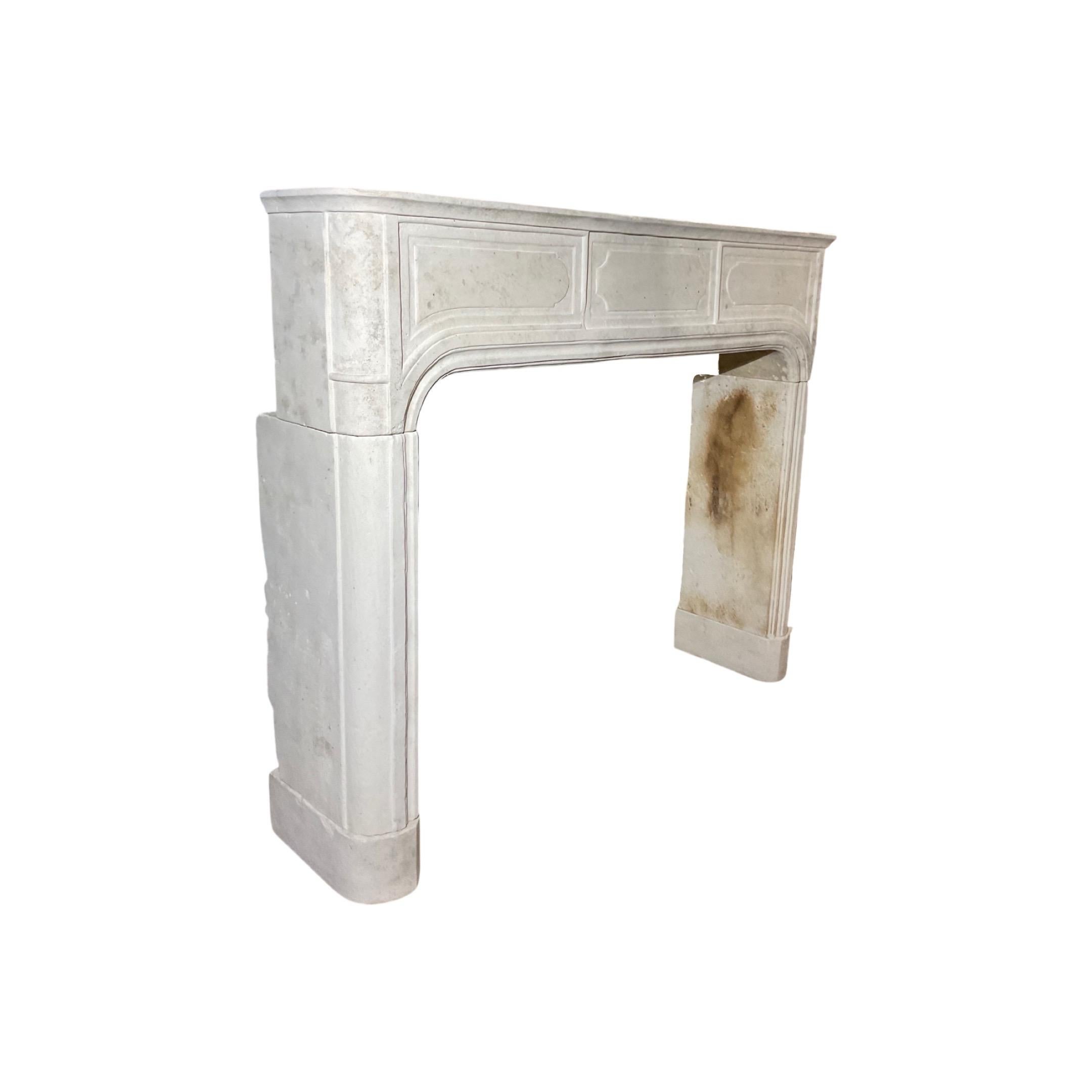 This classic French Limestone Mantel is a timeless piece with intricate Louis XVI style carvings. Crafted in the 1860s, it is a striking and elegant accent piece to any room. The limestone material ensures durability, providing a lasting centerpiece.