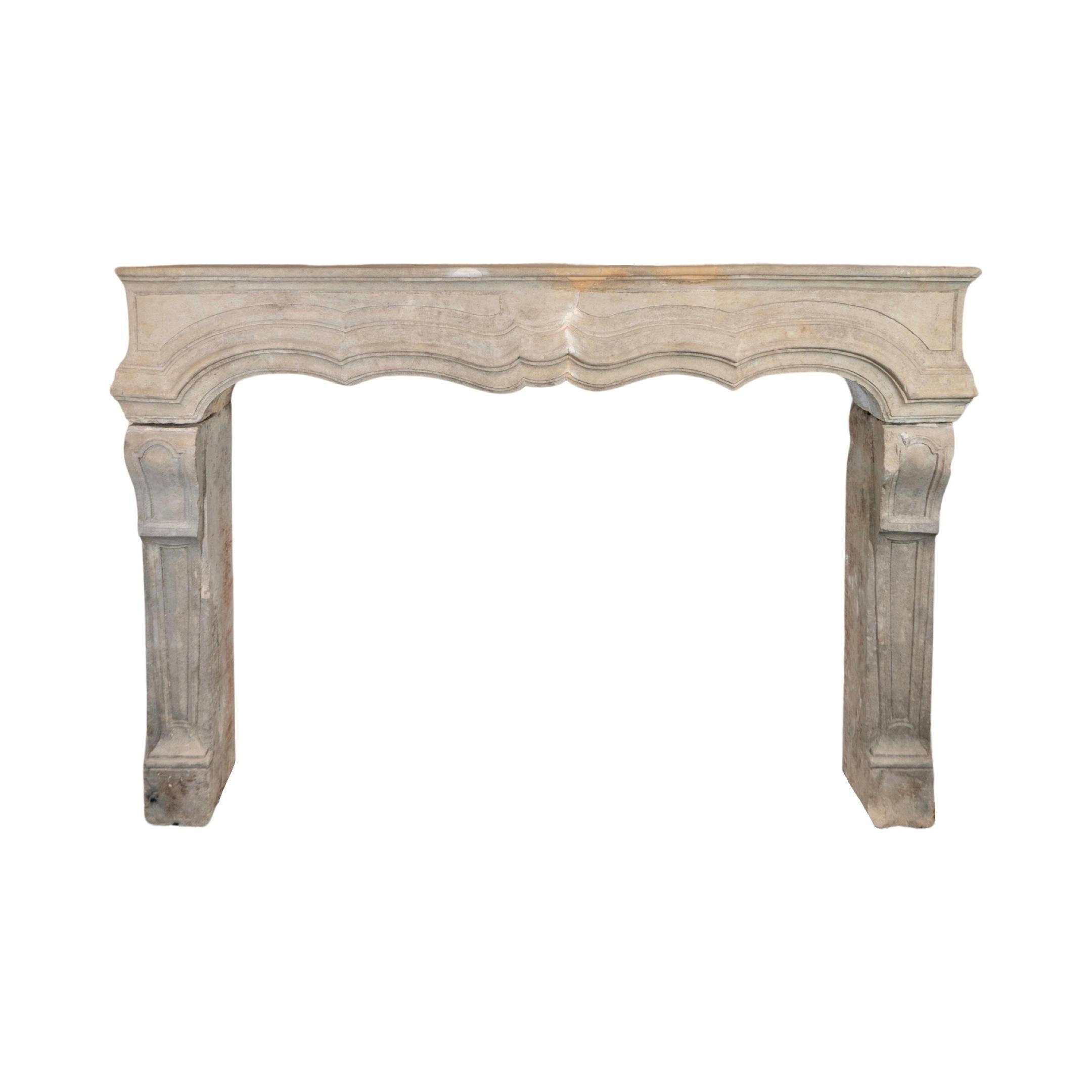This French Limestone Mantel, originating from the 1780s, showcases elegant Louis the 13th style with intricately crafted line carvings. Made from authentic limestone, it adds a touch of sophistication and charm to any room. Bring a piece of France