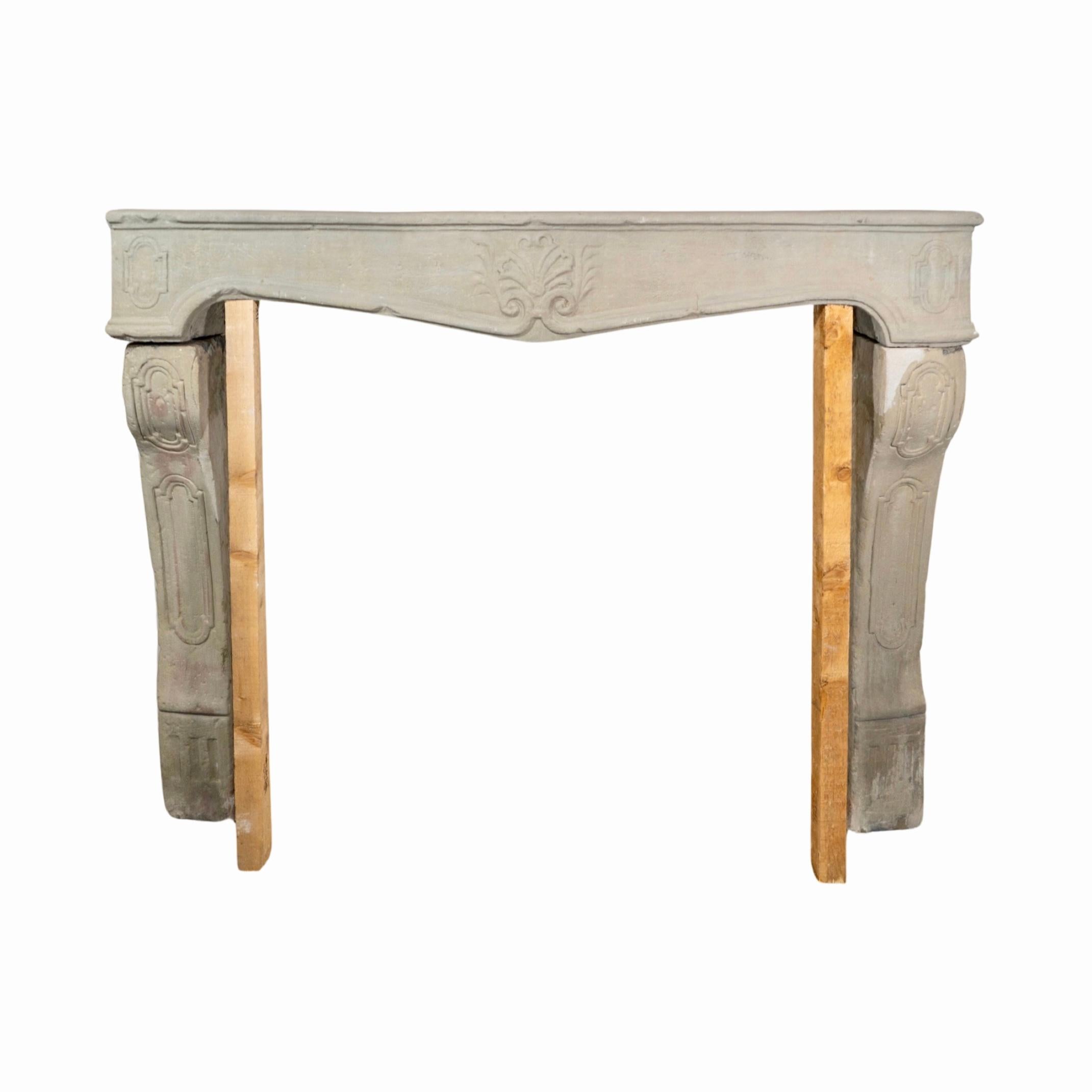 A beautiful French limestone mantel from the 1720s. Crafted in the iconic Louis XVI style with ornate carvings, it's sure to make a statement in any space. Experience the strength and durability of limestone construction for a timeless piece to