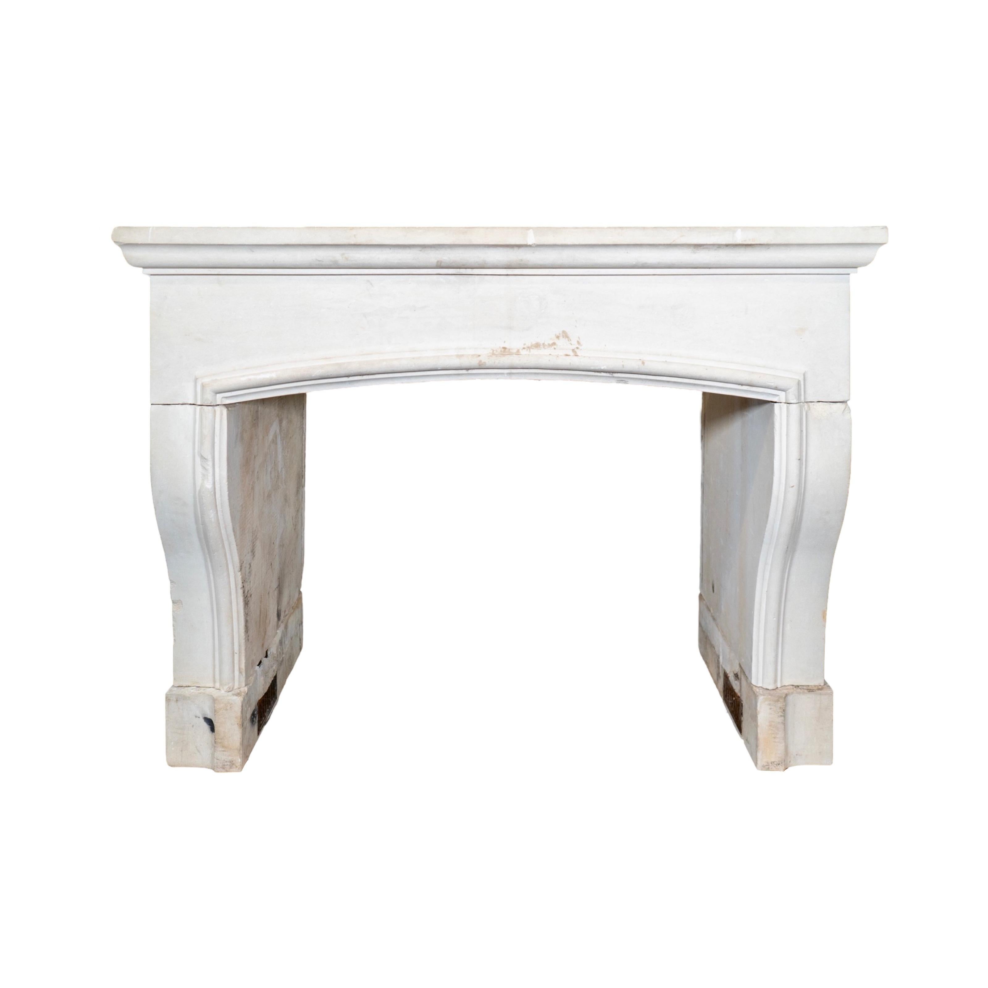 This limestone mantel, reclaimed from an early 1800s French farmhouse, adds a touch of history and elegance to any room. With its timeless design and quality craftsmanship, it serves as a beautiful centerpiece for your fireplace. Bring a piece of