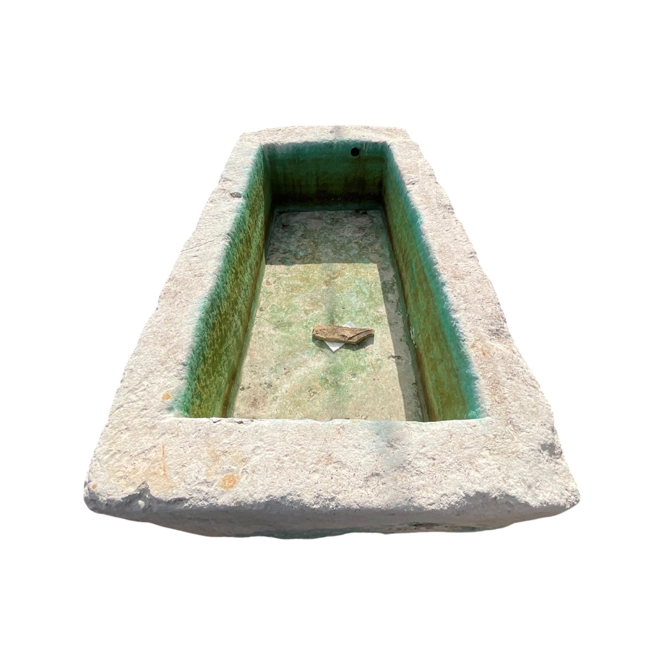 This French limestone trough is the perfect accent for any outdoor area. Expertly sourced from France, this trough is made with strong, durable limestone that is sure to last. Its unique design and natural finish add character and beauty to any