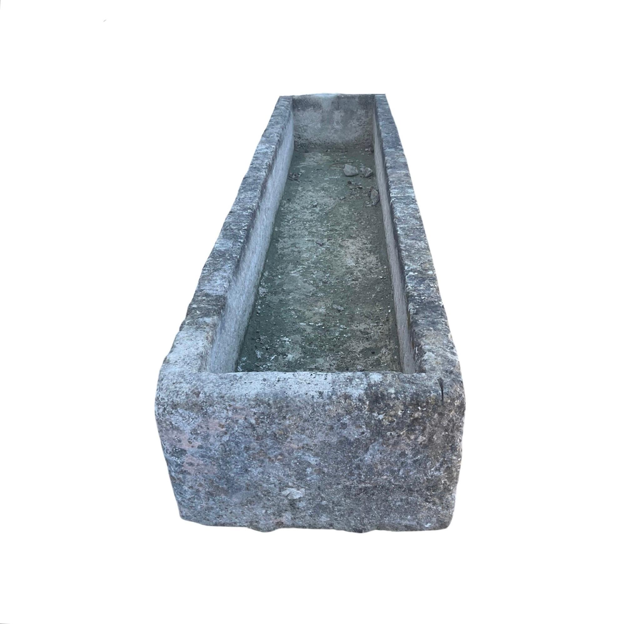 This 17th century antique French limestone trough boasts a large size and timeless style. Crafted from durable limestone, it is the perfect addition to any outdoor space. Its trough design allows for easy gardening and adds a classic touch to your
