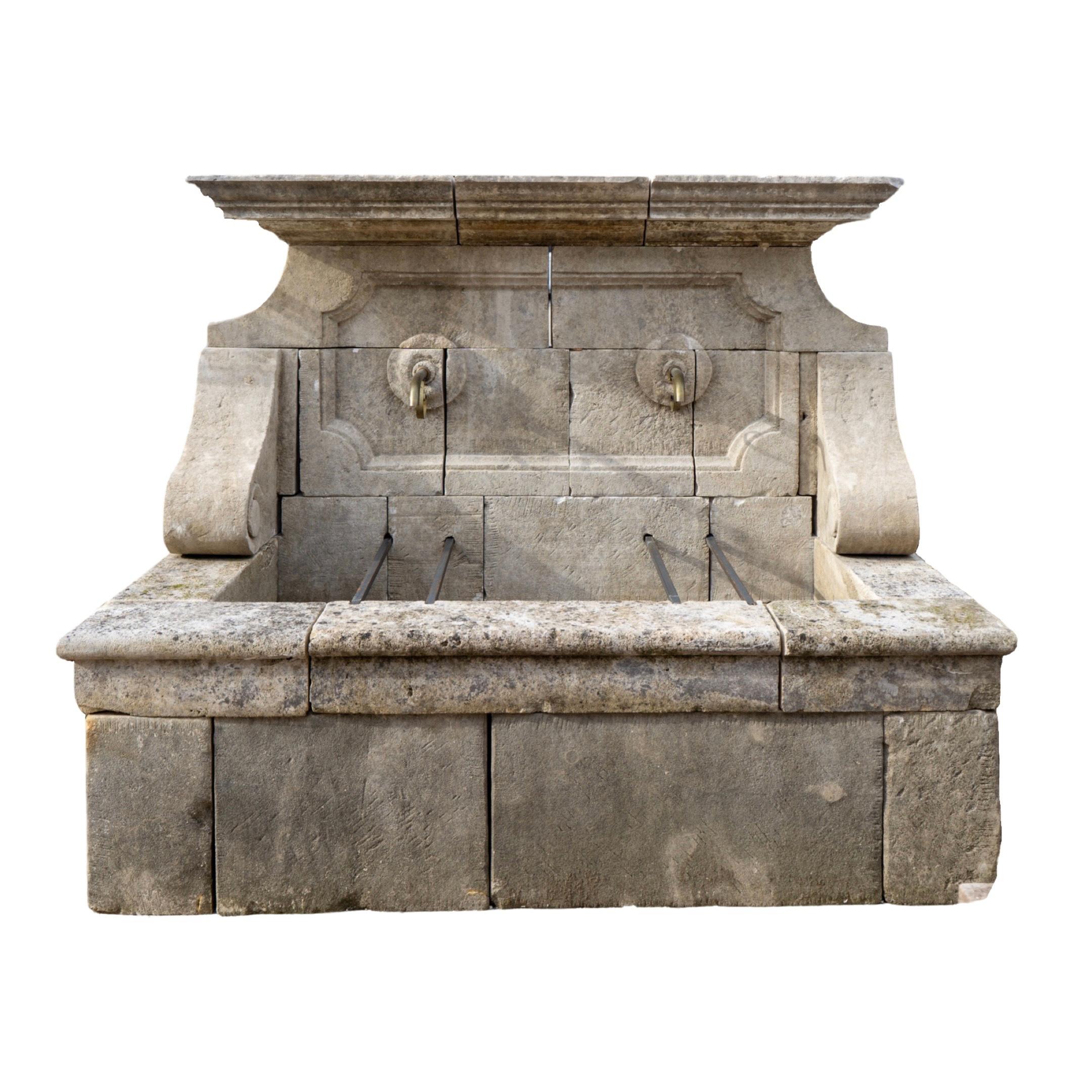 This French limestone wall fountain from the 1880s adds a touch of elegance and sophistication to any outdoor space. With a wide rectangular front basin and pre-drilled water holes for efficient drainage and overflow, this fountain is both beautiful