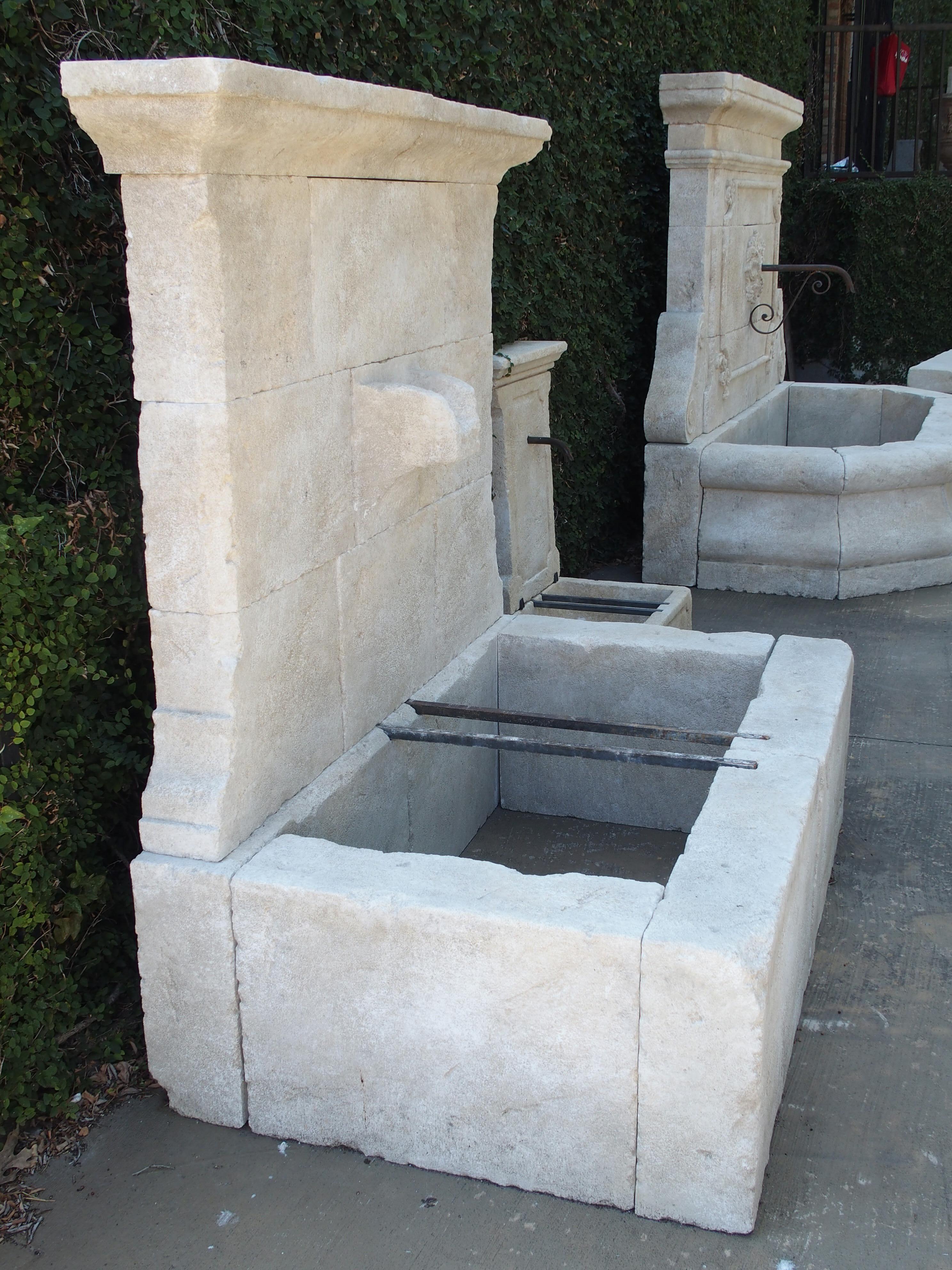 This French limestone wall fountain is a good in-between size at roughly 5 feet high and 5 feet wide. The overall shape is rectilinear, and it comes with a unique carved stone spout. The design works equally well with classic or contemporary