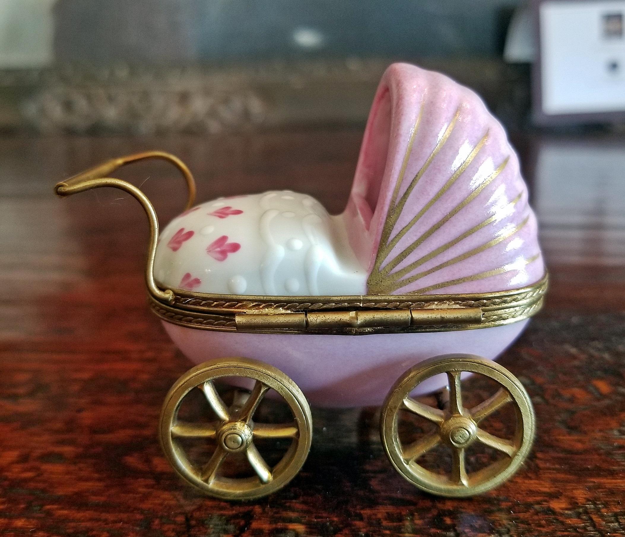 Pink with whites and yellow.

Fully marked……..from circa 1910.

Gilt metal (Ormolu) wheels that move…..gilt metal (Ormolu) Handles and trim..

One of the cutest Limoges pieces we have seen!!
A perfect gift for a new mother!!
Limoges