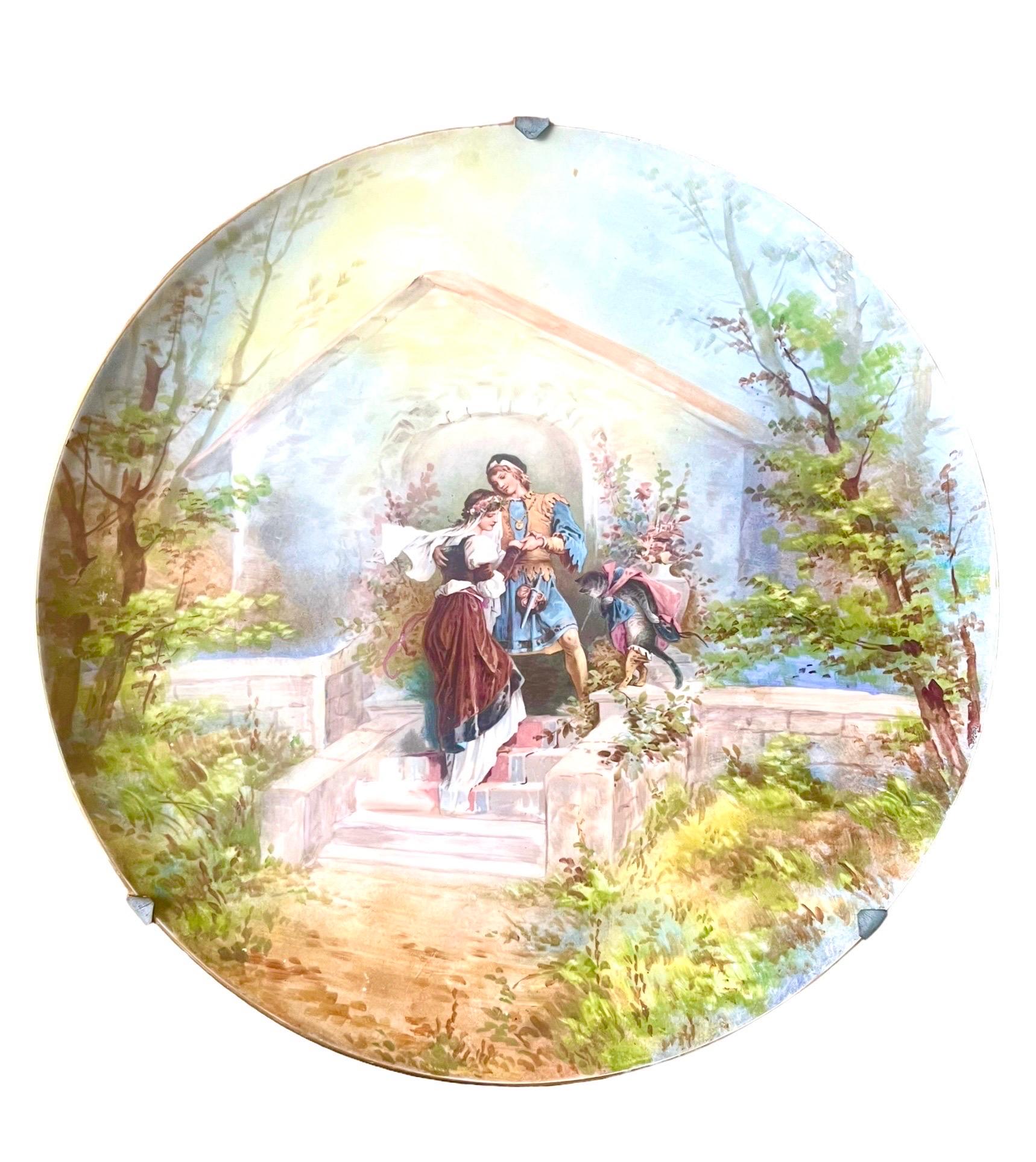 Very beautiful large plate, decorative dish in good quality porcelain with polychrome painted decoration of a final scene from Charles Perrault's famous tale Puss in Boots, written at the end of the 17th century.
The colors are bright and the scene