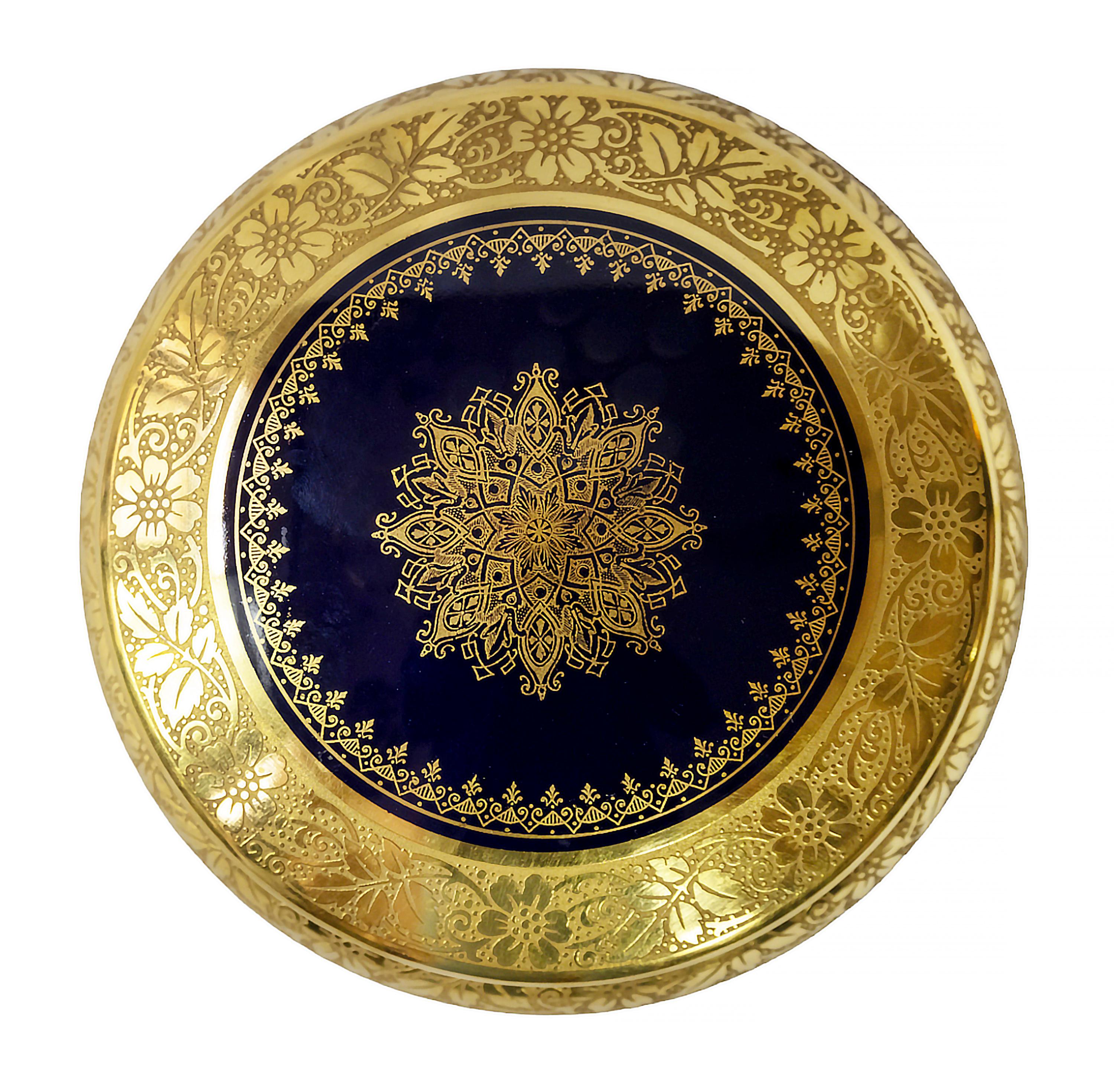 Cobalt blue porcelain jewelry box richly decorated with gold decor produced by Limoges France.
Marked on the bottom.