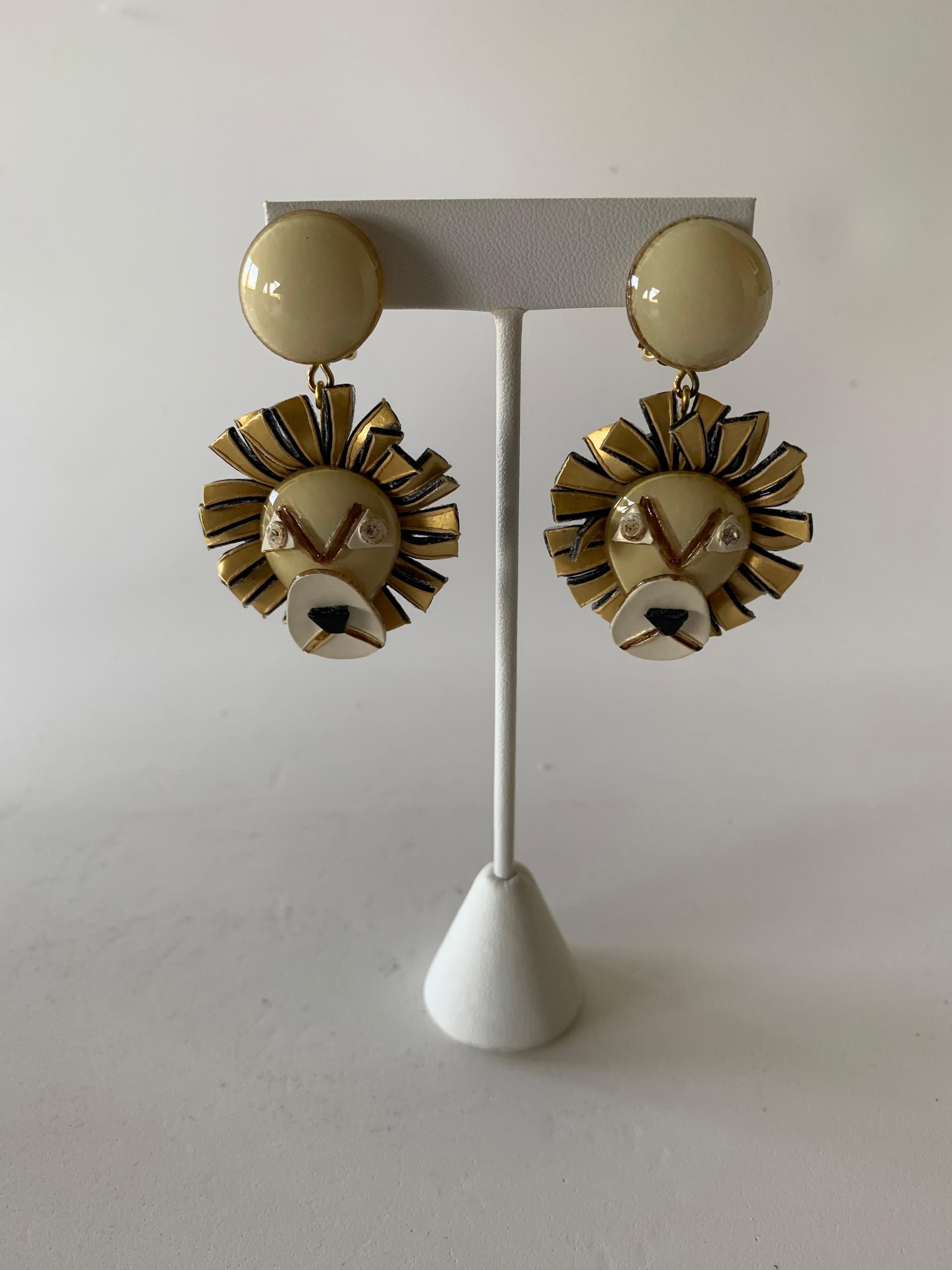 Light and easy to wear, contemporary handmade artisanal clip-on statement earrings were made in Paris by Cilea. The lightweight earrings feature charming lions. The lion's three-dimensional oversized face features bright colors in hues of taupes and
