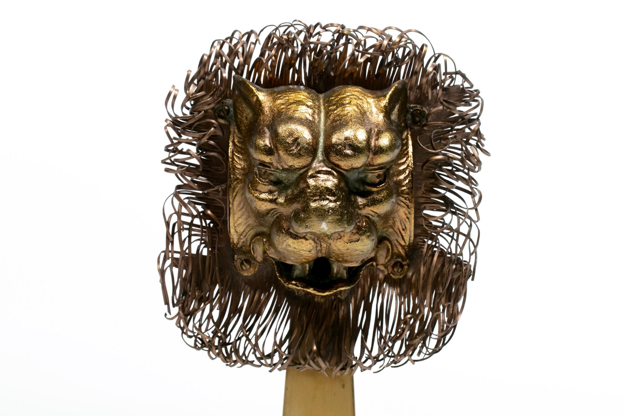 Chic pair of French brutalist lion head andirons with large golden manes. Lot of details so have a close look. Check out that profile. Gorgeous lion faces guard the hearth with their eyes all on you. They glow exquisitely with a roaring fire.
