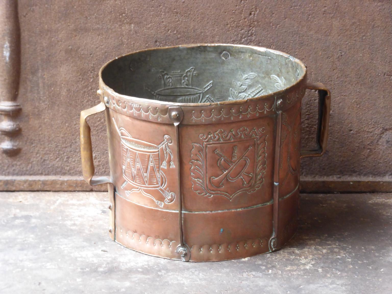 18th-19th century French Neoclassical firewood basket made of copper. A socalled 'ferrat' from the the Auvergne, France. Old copper container reinforced with a frame and adorned with copper bands with which the women went to fetch water. They wore