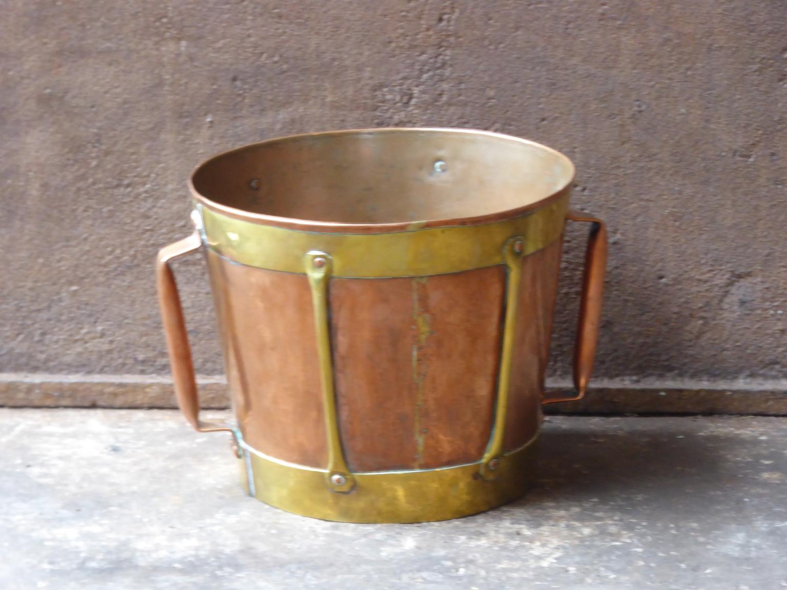 18th-19th century French neoclassical firewood basket made of copper and copper A socalled 'ferrat' from the Auvergne, France. Old copper container reinforced with a frame and adorned with brass bands with which the women went to fetch water. They
