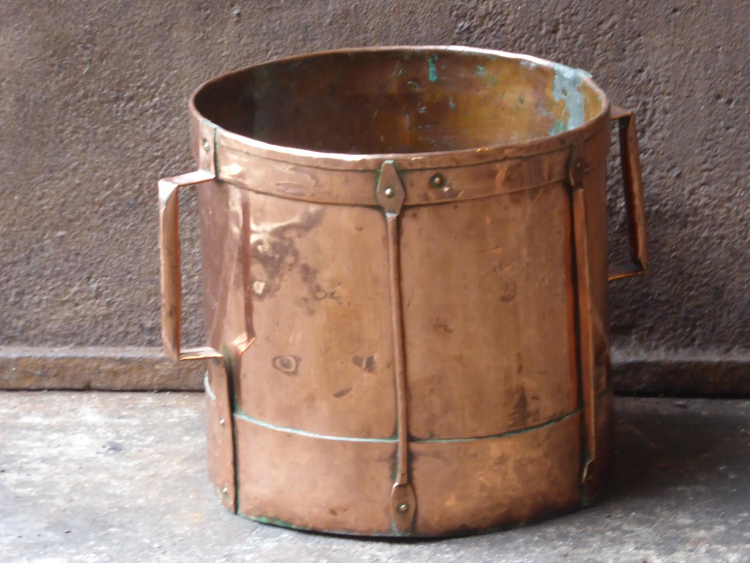 18th-19th century French neoclassical firewood basket made of polished copper. A so-called 'ferrat' from the Auvergne, France. Old copper container reinforced with a frame and adorned with copper bands with which the women went to fetch water. They