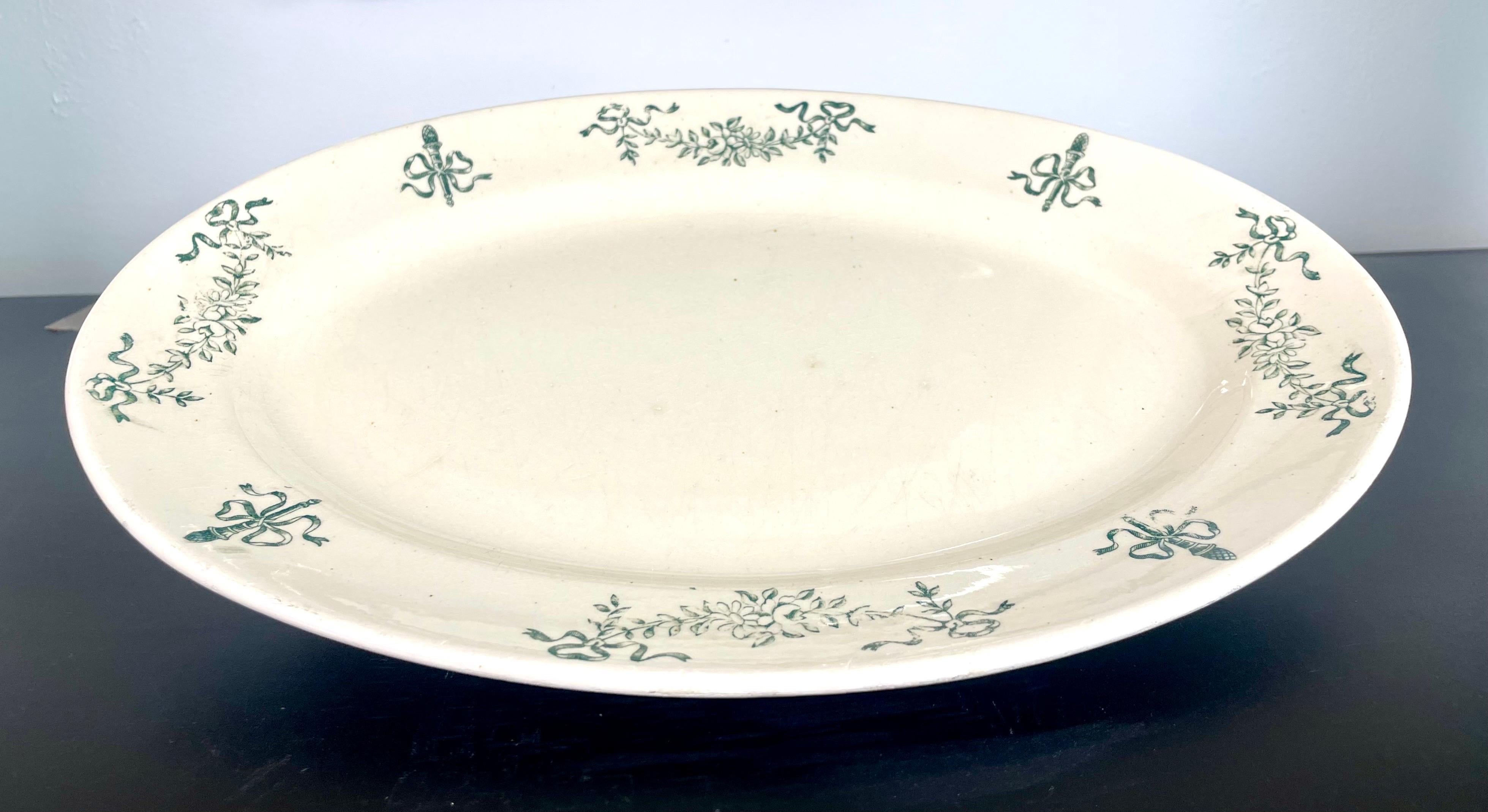 Longchamp Earthenware Oval Serving Dish - Iron Land
The earthenware is white ivory decorated with ribbons and garlands of flowers.
The bluish green gray-green color is characteristic of Longchamp Terre de fer.
France - Late 19th

