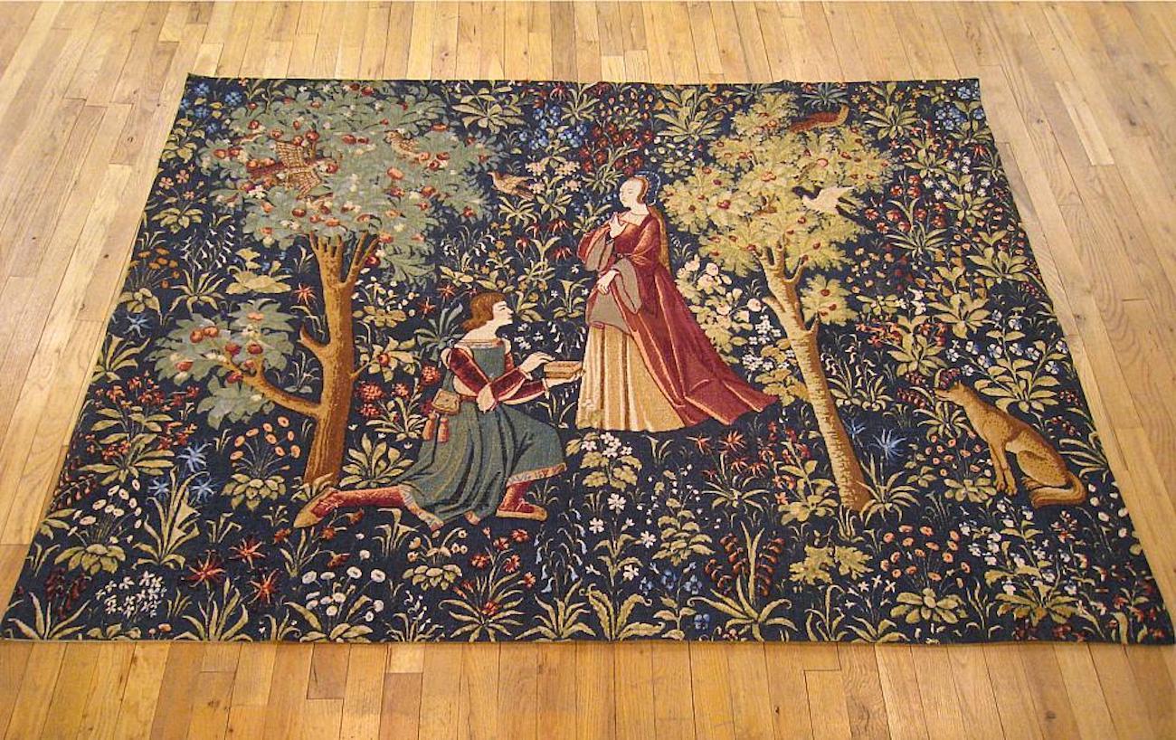 A French Aubusson loomed mille fleurs tapestry panel from circa 1910, a replica of 15th century French tapestry designs and reminiscent of the early Gothic tapestries, featuring an allegorical courtship scene between a young noble and his lady