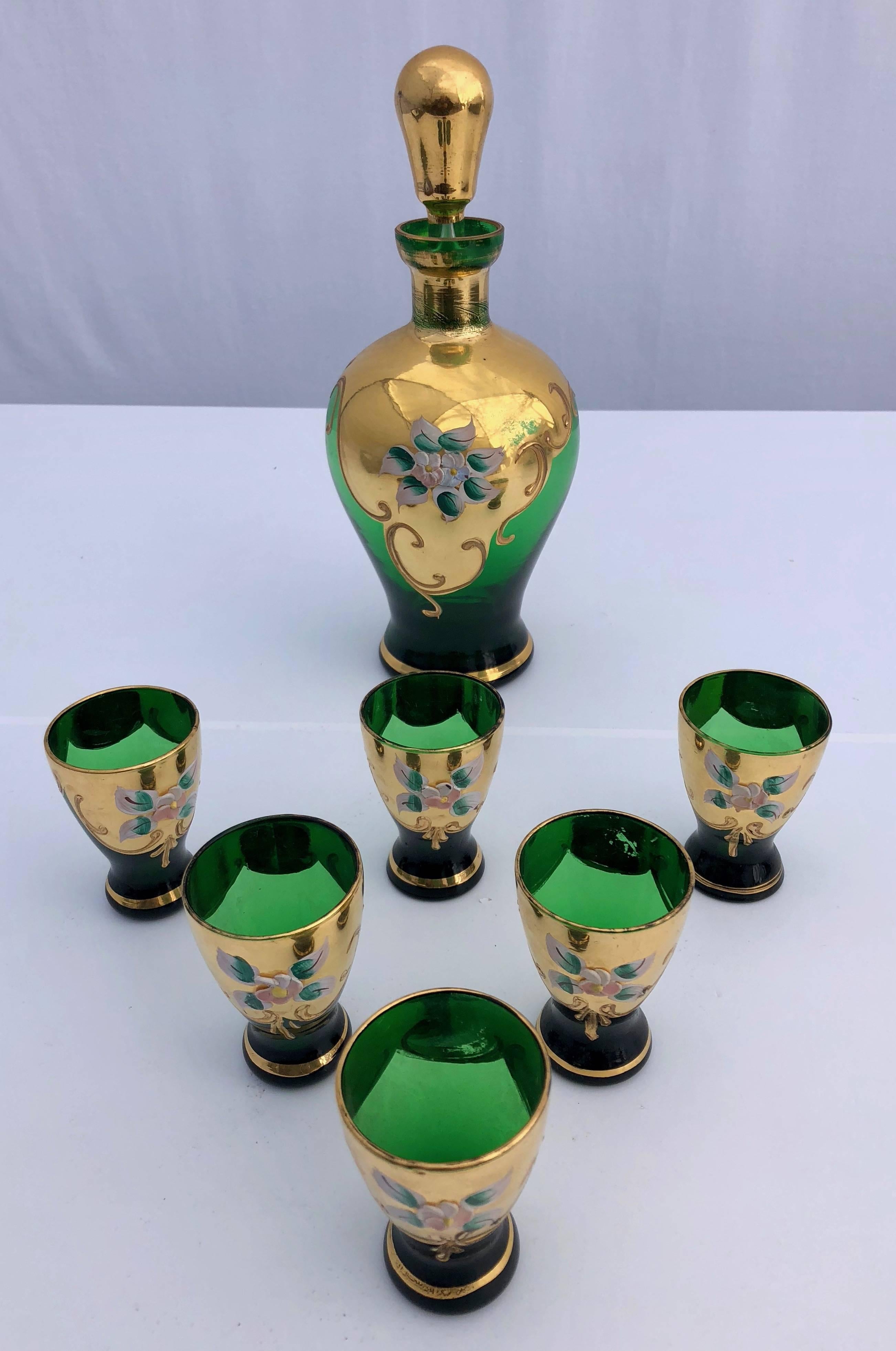 This gorgeous handblown, hand-painted French Lorraine enameled liquor set include a carafe, with its beautiful gold stopper, and six small glasses. The emerald green color is exquisite and enhanced with hand painted gold enamel and flowers. It is