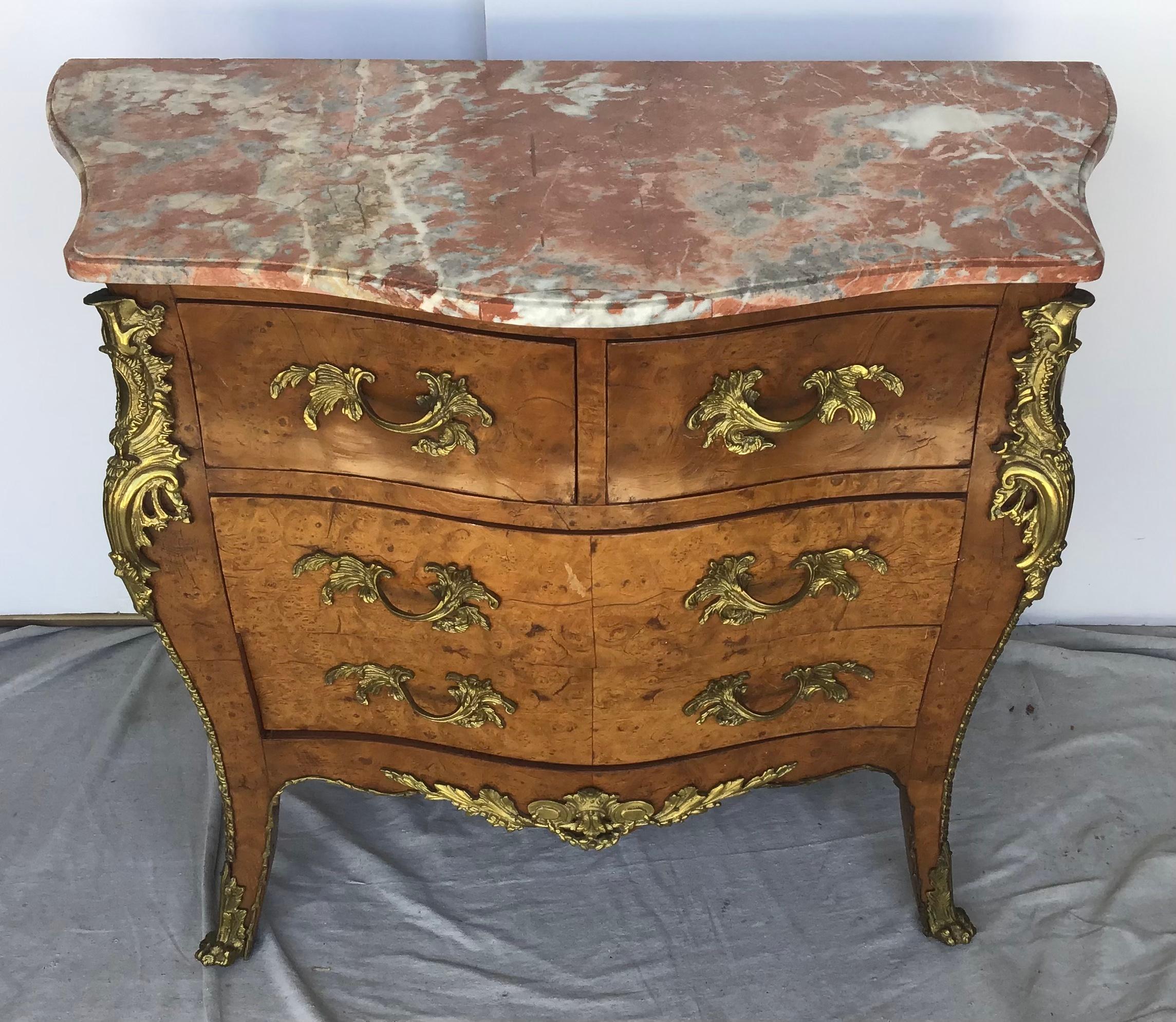 A very elegant Louis XV style bombe shaped commode. This chest of drawers has Omalu decoration, gorgeous marquetry and red and white marble top.