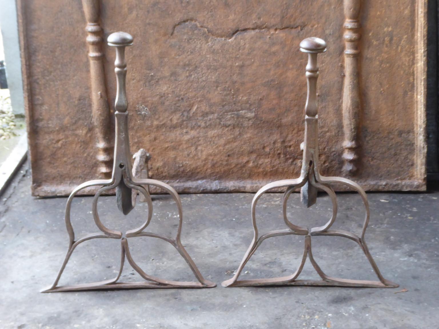 Beautifully forged 17th century Dutch andirons made of wrought iron. The style of the andirons is Louis III. They are in a good condition.