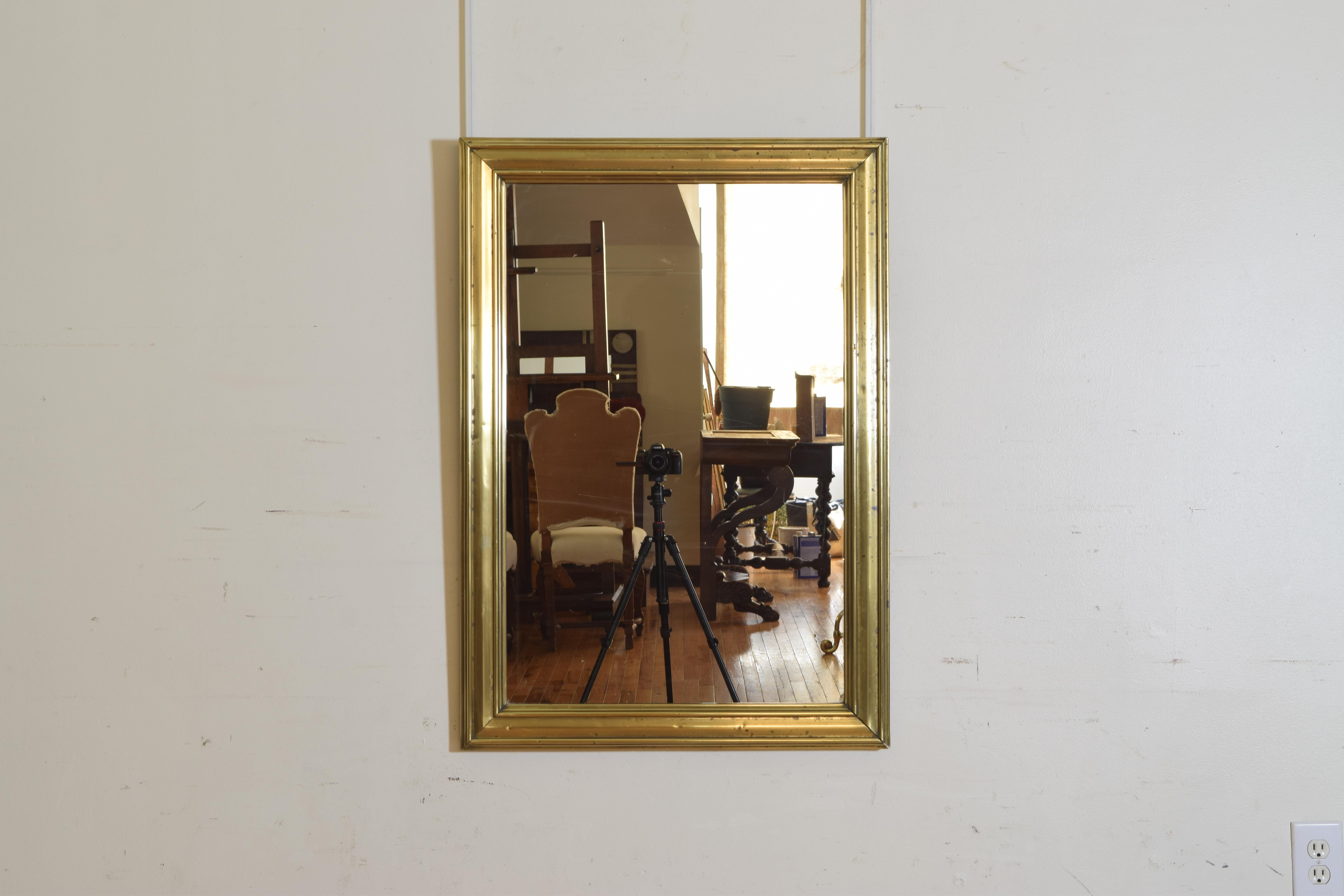 Not as large as the majority of these brass bistro mirrors we find this mirror has a cast brass frame with inner and outer moldings applied to a wooden backing, retaining original mid-19th century mirror plate.