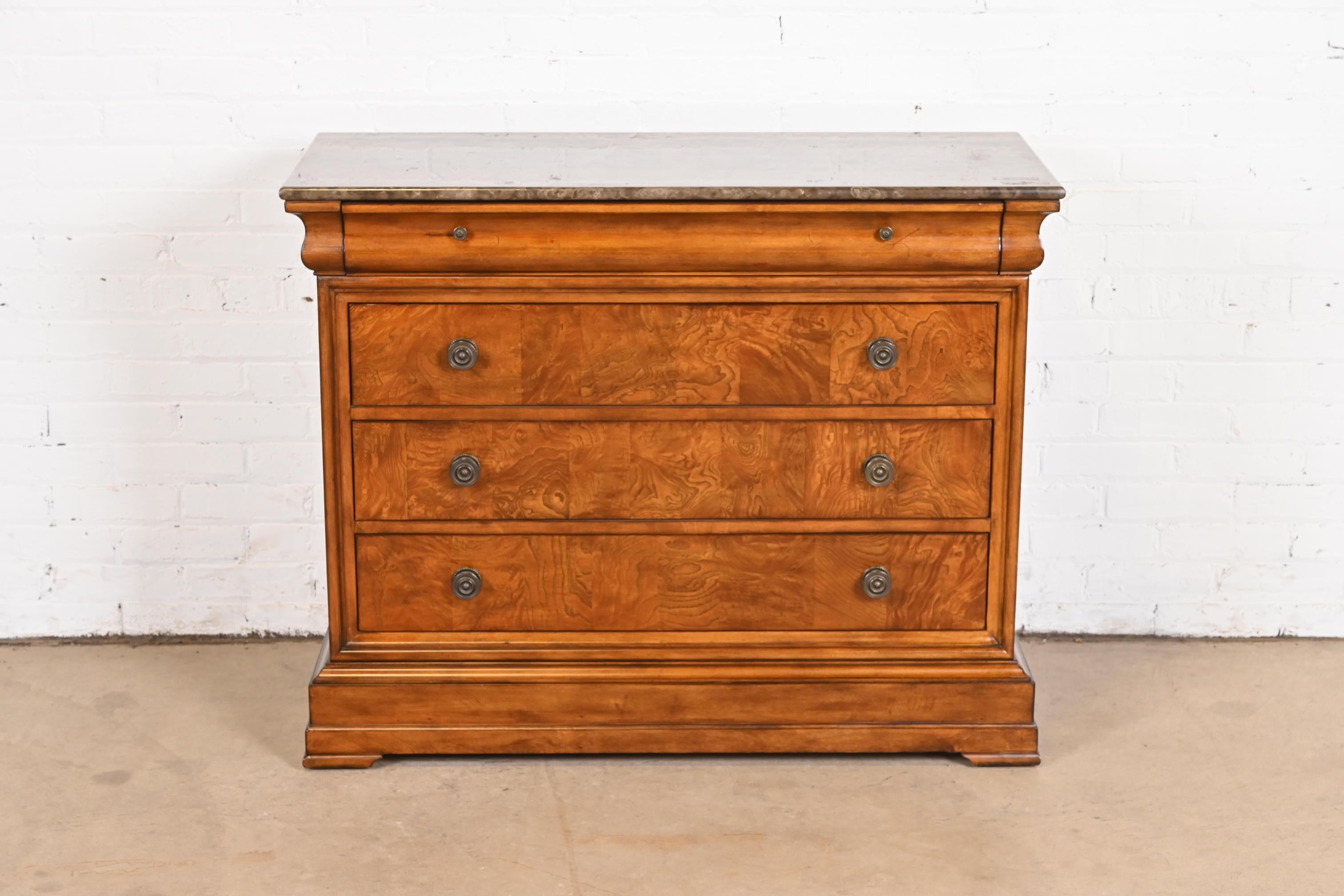 A gorgeous French Louis Philippe style four drawer chest or commode

USA, Late 20th Century

Burl and cherry wood, with marble top and original brass hardware.

Measures: 42.5