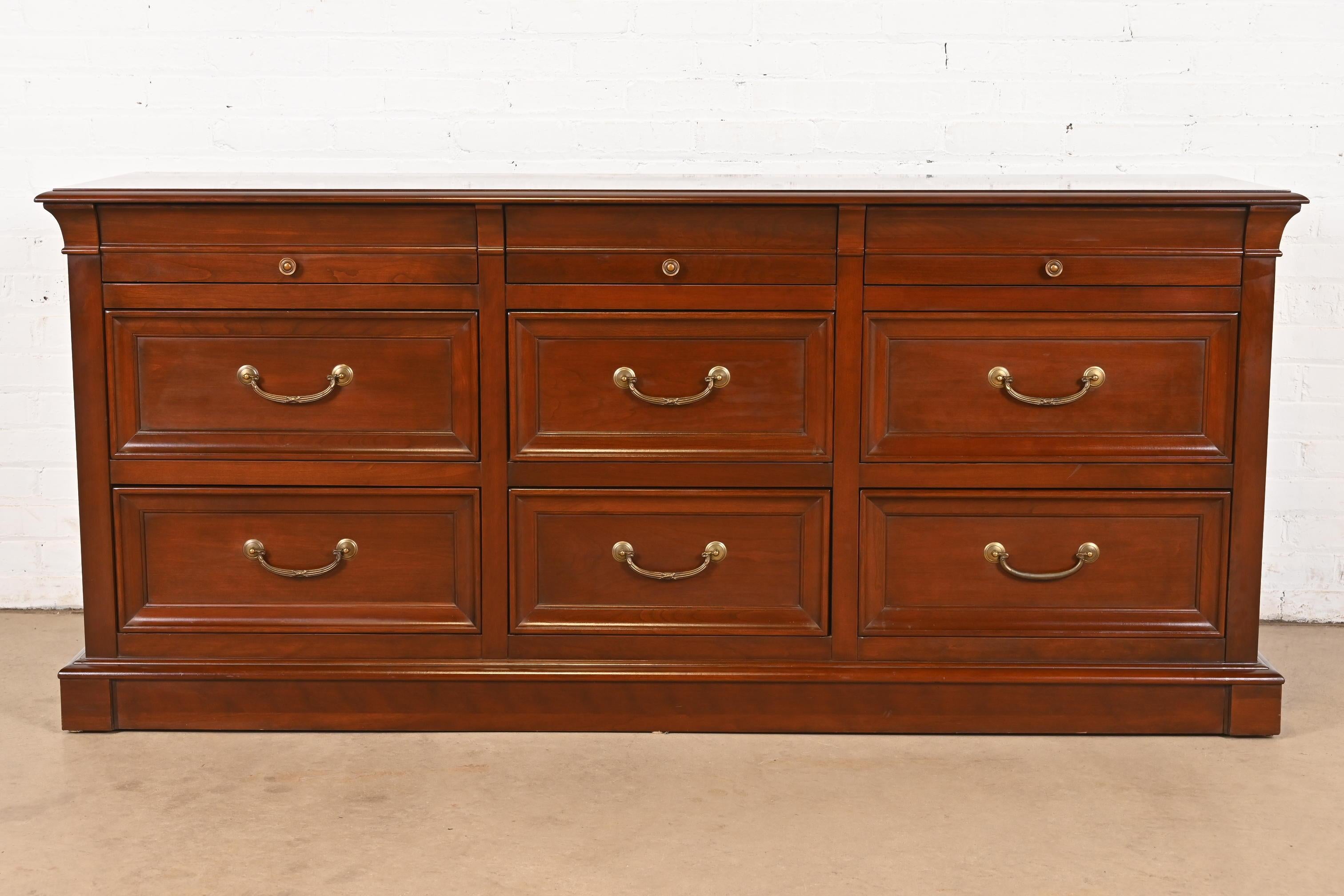 Eine prächtige Kommode mit neun Schubladen im französischen Regency- oder Louis-Philippe-Stil

USA, Ende des 20. Jahrhunderts

Massives Kirschbaumholz, mit originalen Messingbeschlägen.

Maße: 72 