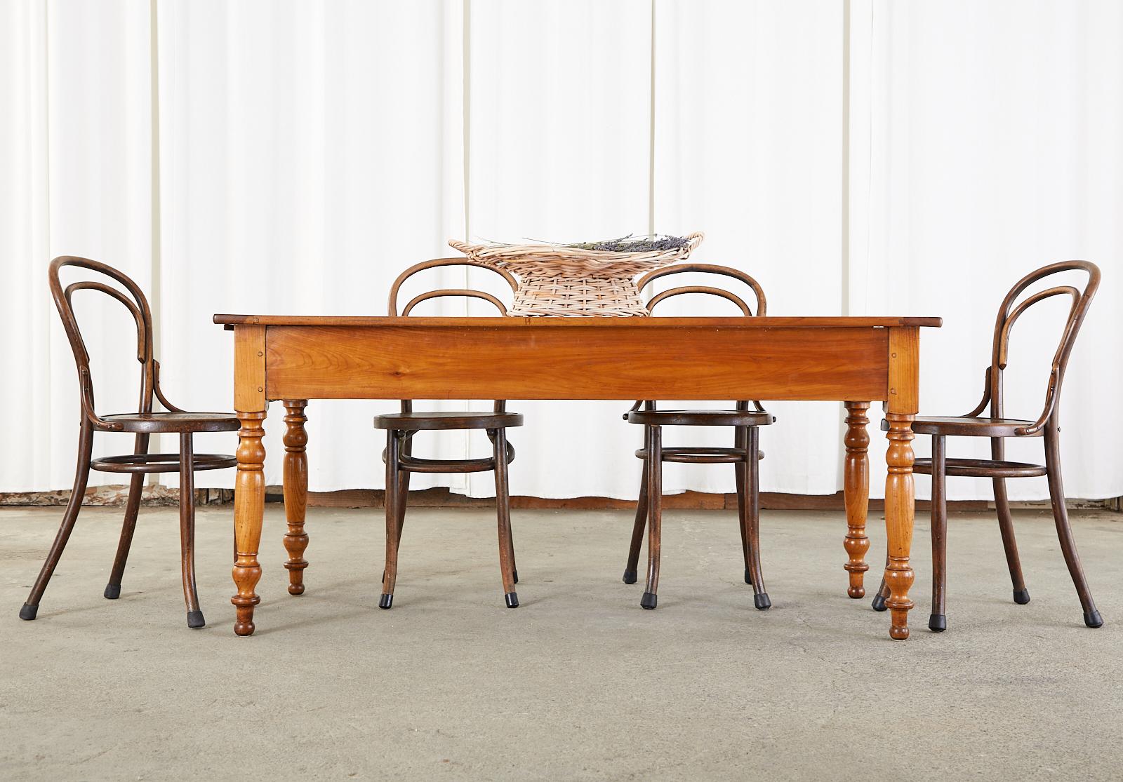 Rustic 19th century French Louis Philippe period farmhouse work table or console table. Beautifully crafted from fruitwood with peg joinery. The plank top has breadboard ends and showcases the rich grain patterns of the wood. The frieze is fitted