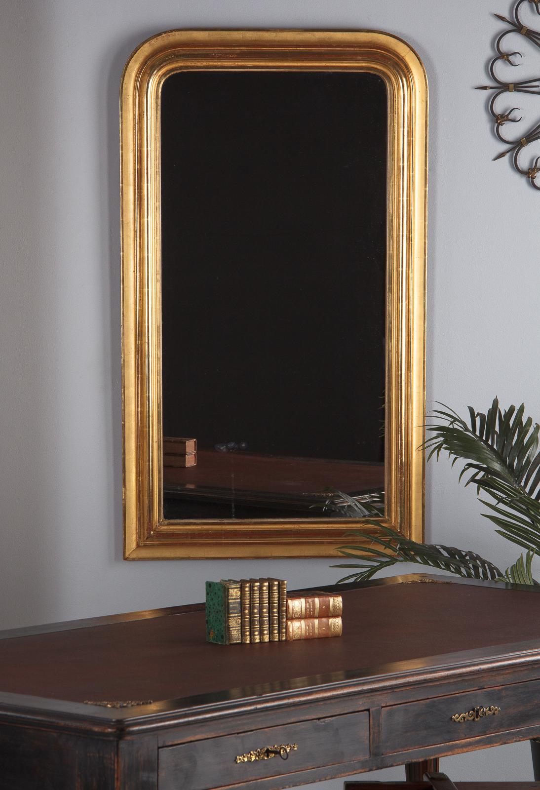 A classic, large gold leaf Louis Philippe mirror, French, circa 1850. All original with no restoration. Molded edge wood frame with arched top corners, gilt with alternating glossy and matte surfaces. Variation in gilding due to application, which