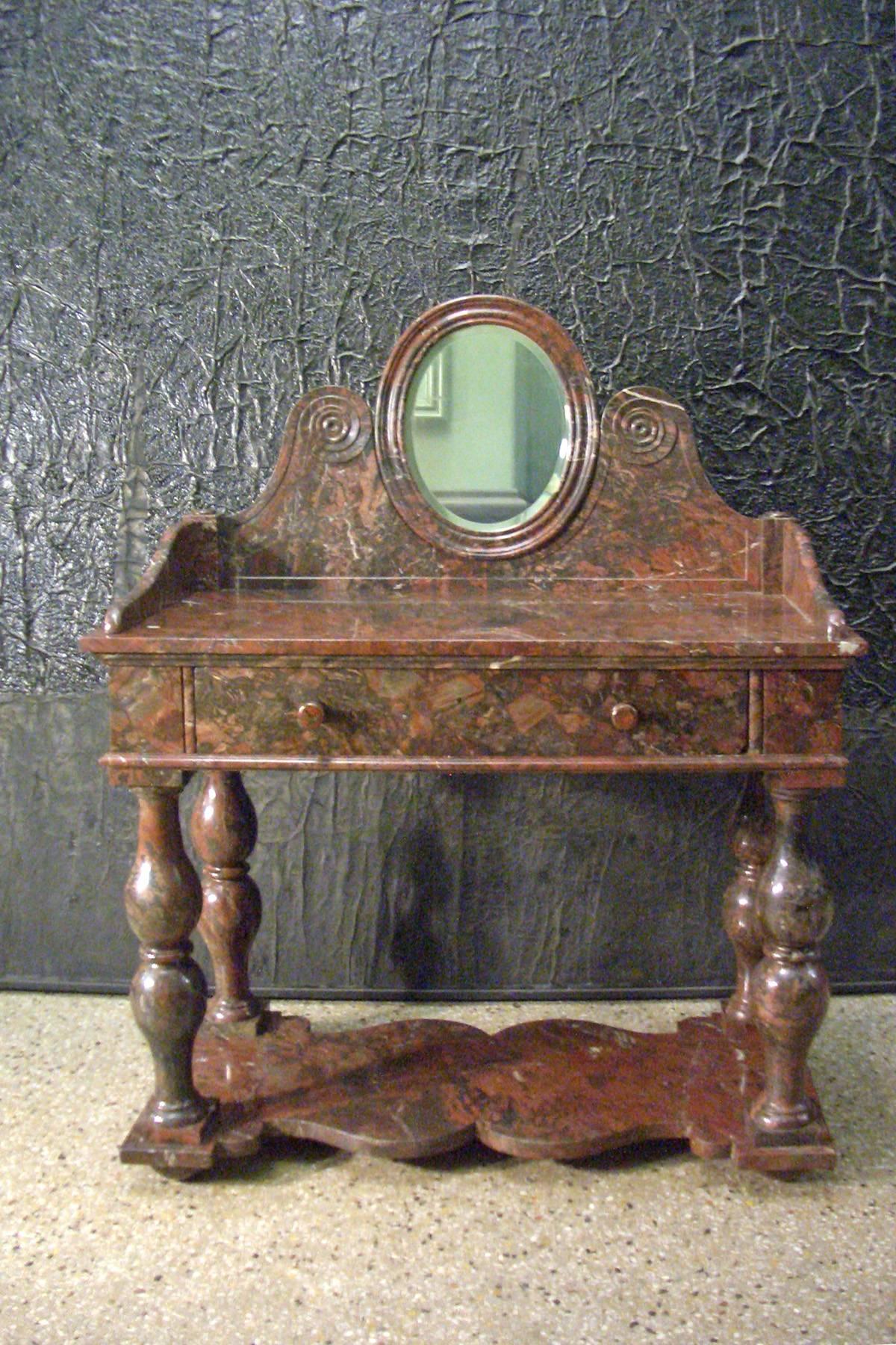 Very rare console table made of solid Griotte Rouge marble, that can transform from a conventional dressing table/vanity into a special serving console or into a bar, or....
In three parts, the turned double baluster legs connected by a base-slab on