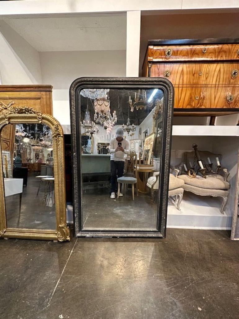 19th century French Louis Philippe black lacquered and silver leaf mirror. Circa 1870. Sure to make a statement!