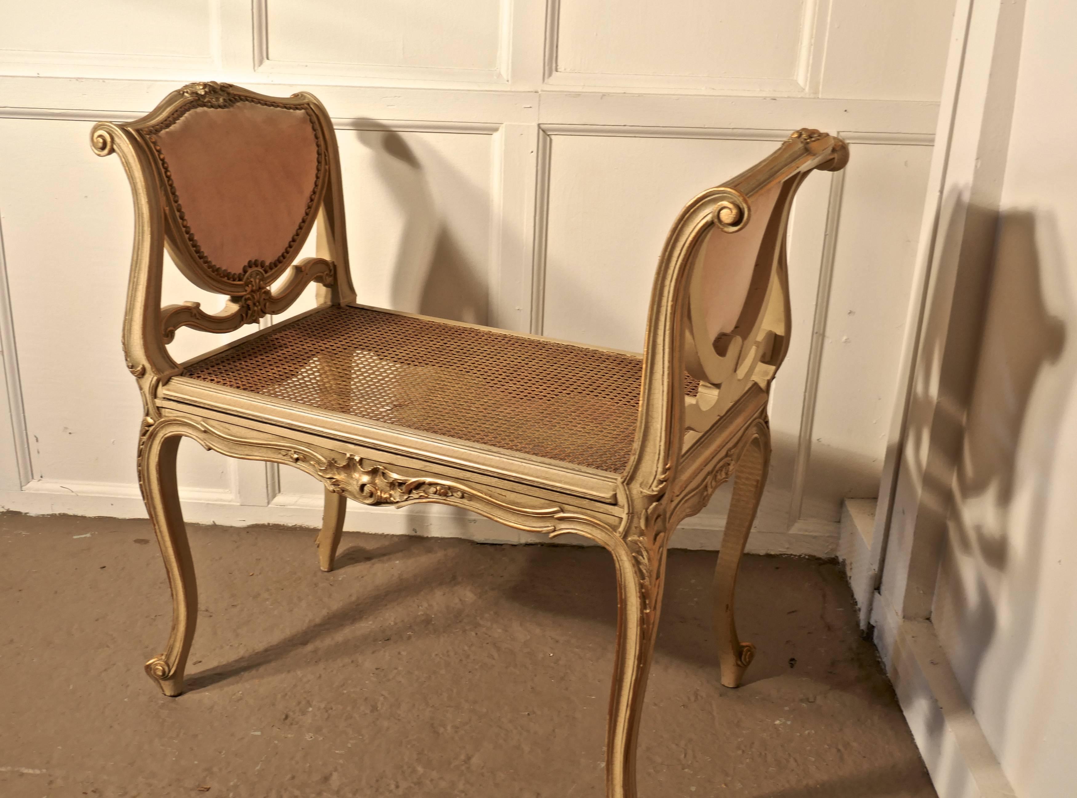 A French Louis Philippe painted and gilt boudoir window seat

This is a delightful piece of Louis style painted chic furniture, the high arms on either side has heart shaped panels upholstered in dusky pink velour
The painted legs, arms and apron