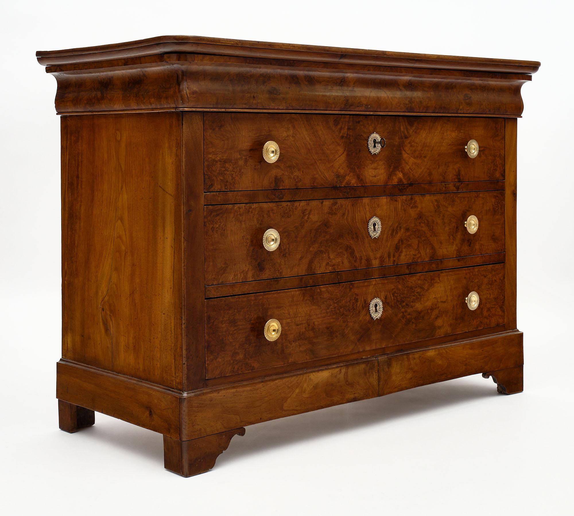 Chest of “commode” from the French Louis Philippe period. This piece is made of solid walnut and burled walnut from the Rhone Valley. It has been finished with a lustrous French polish finish. The hardware is all finely cast bronze.