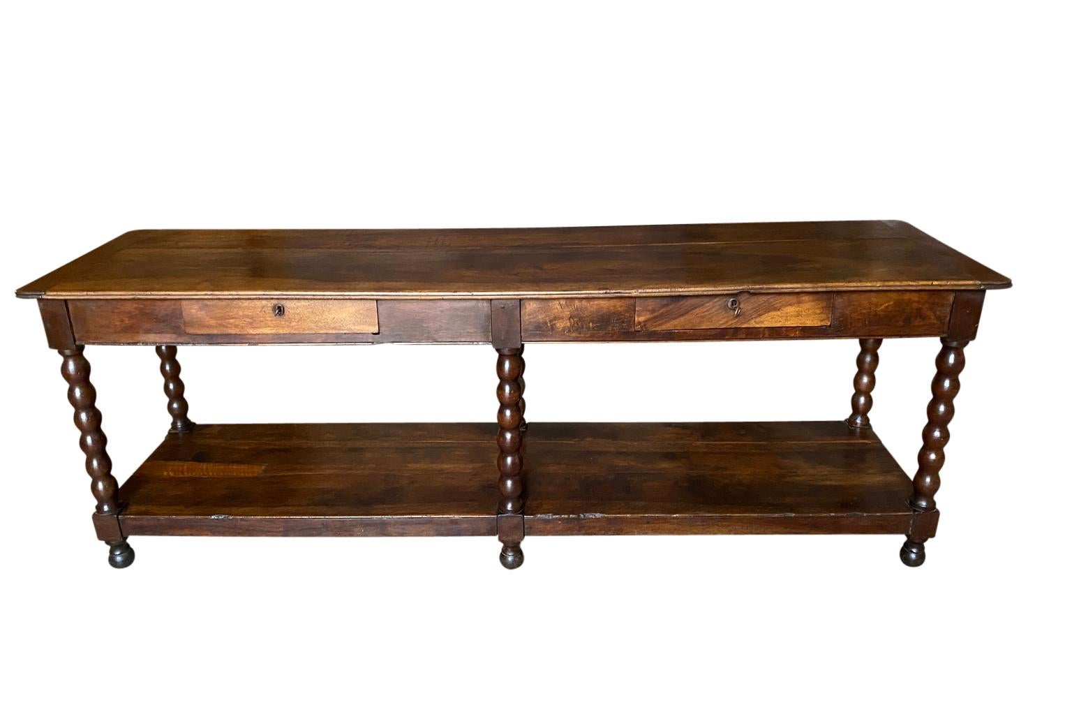 A very handsome Louis Philippe period Draper's Table from the South of France.  Wonderfully constructed from beautiful walnut with 2 drawers, nicely turned legs and a lower shelf.  A wonderful console table with terrific patina.