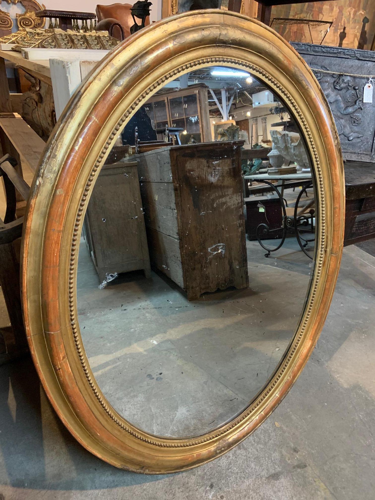 A very handsome French Louis Philippe period mirror in giltwood of large scale. Beautiful Minimalist design. Handsome patina.