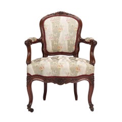 French Louis Philippe period walnut arm chair with paired footstool, c. 1850's
