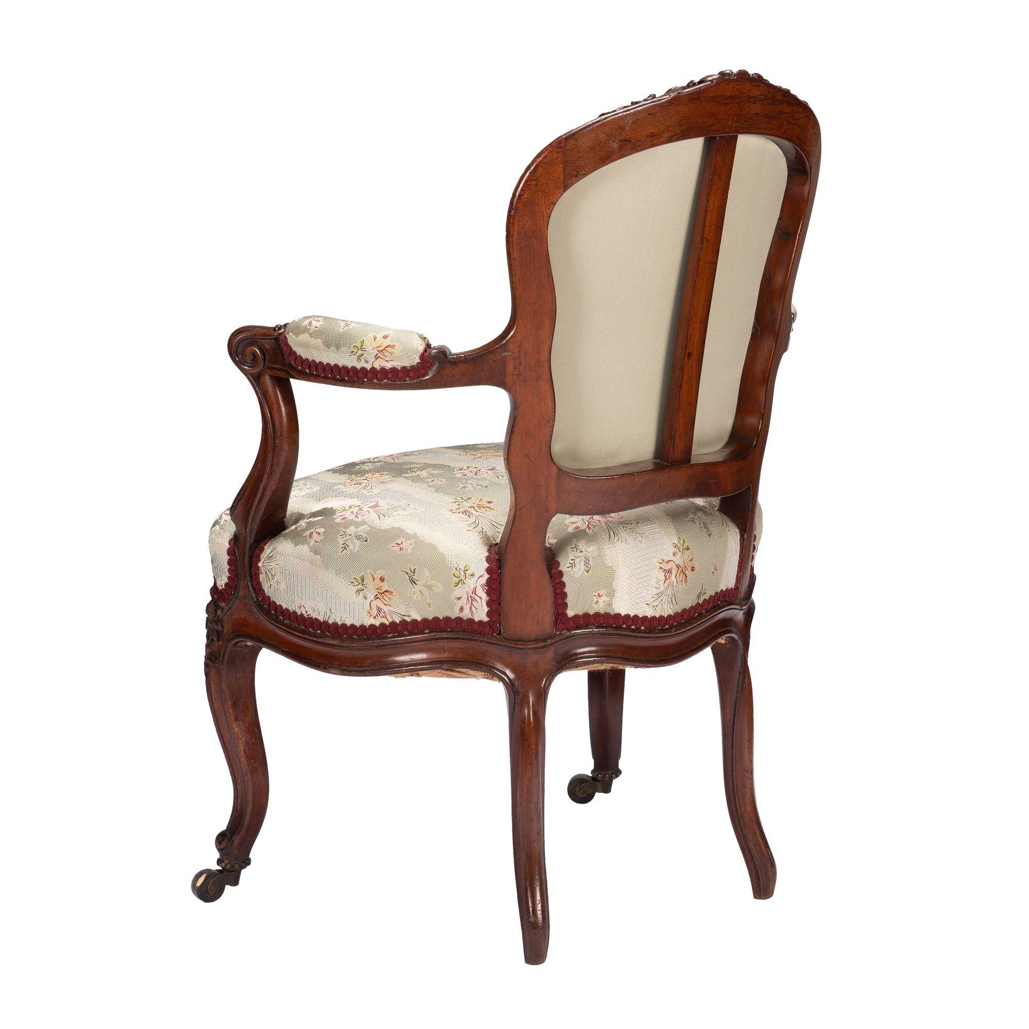 Brass French Louis Philippe period walnut arm chair with paired footstool, c. 1850's For Sale