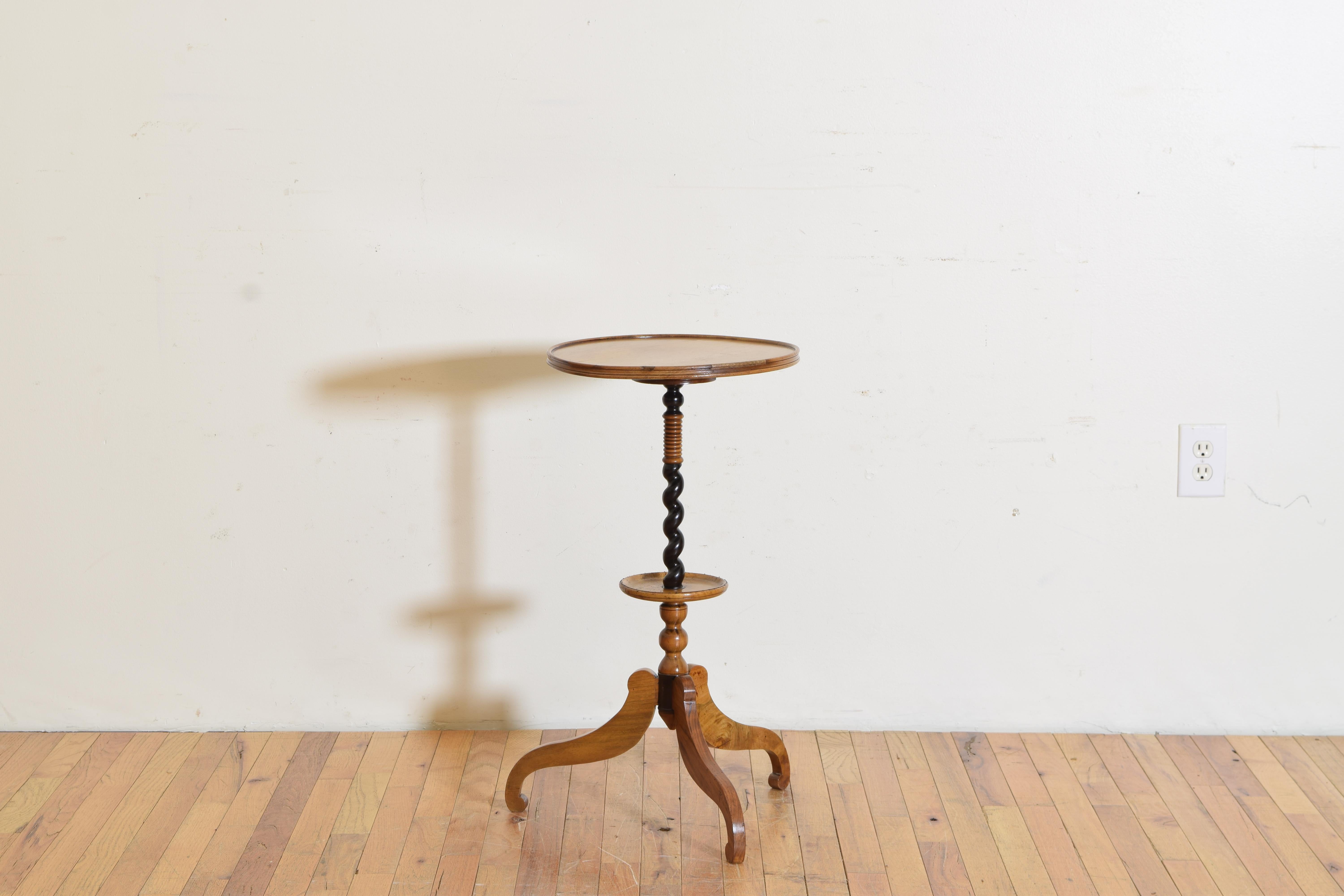 Having two tiers with molded edges raised on a spiral twist pedestal and ending on a tripartite base.