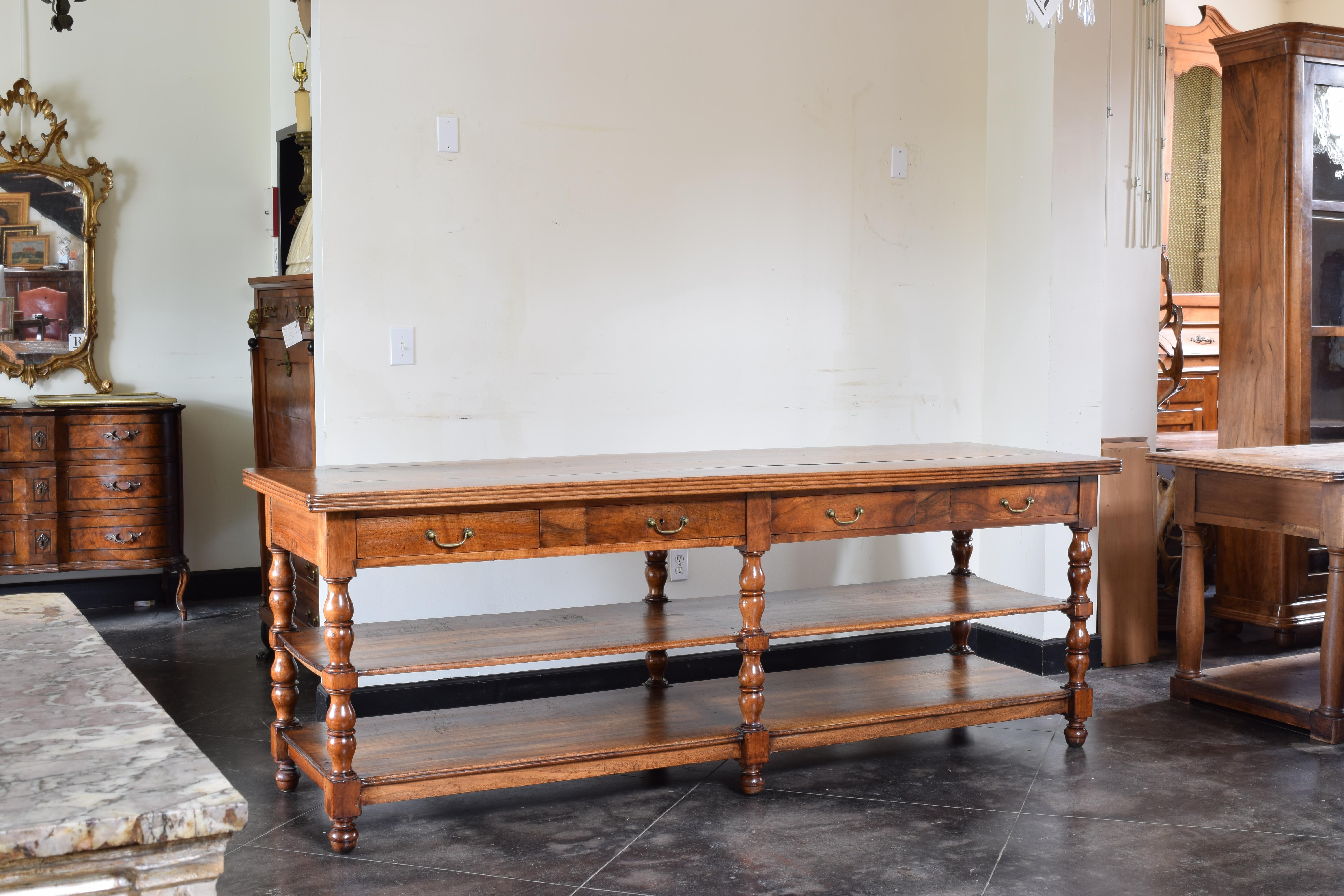 Having a thick rectangular top with quadruple molded edge, the moldings used as scissor guides for cutting fabric, the conforming case with 4 drawers retaining antique brass hardware, raised on beautifully turned and block legs terminating in acorn
