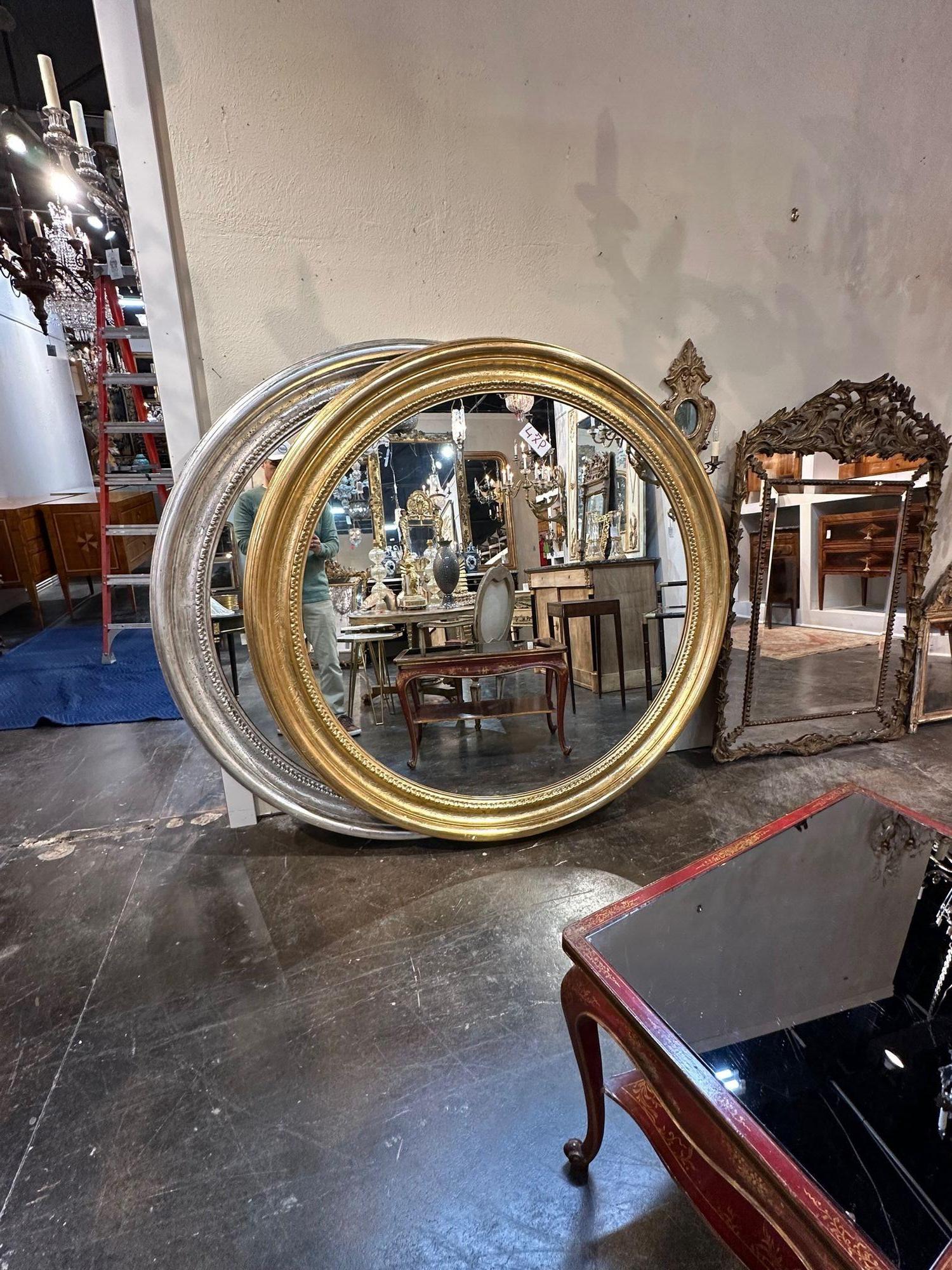 Large and impressive French Louis Philippe style round mirror. circa 2000. A favorite of top designers. Note 2 available in gold and silver, these are sold as each.