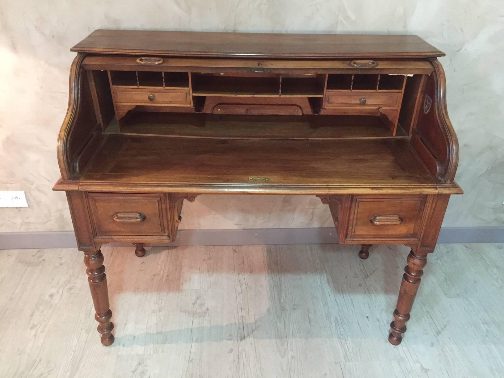 Very nice French Louis Philippe walnut cylinder writing desk with curtain, opening to reveal an arrangement of small drawer and compartment.
The writing surface can be pulled to have a larger work surface.
There are two large drawer in the front.