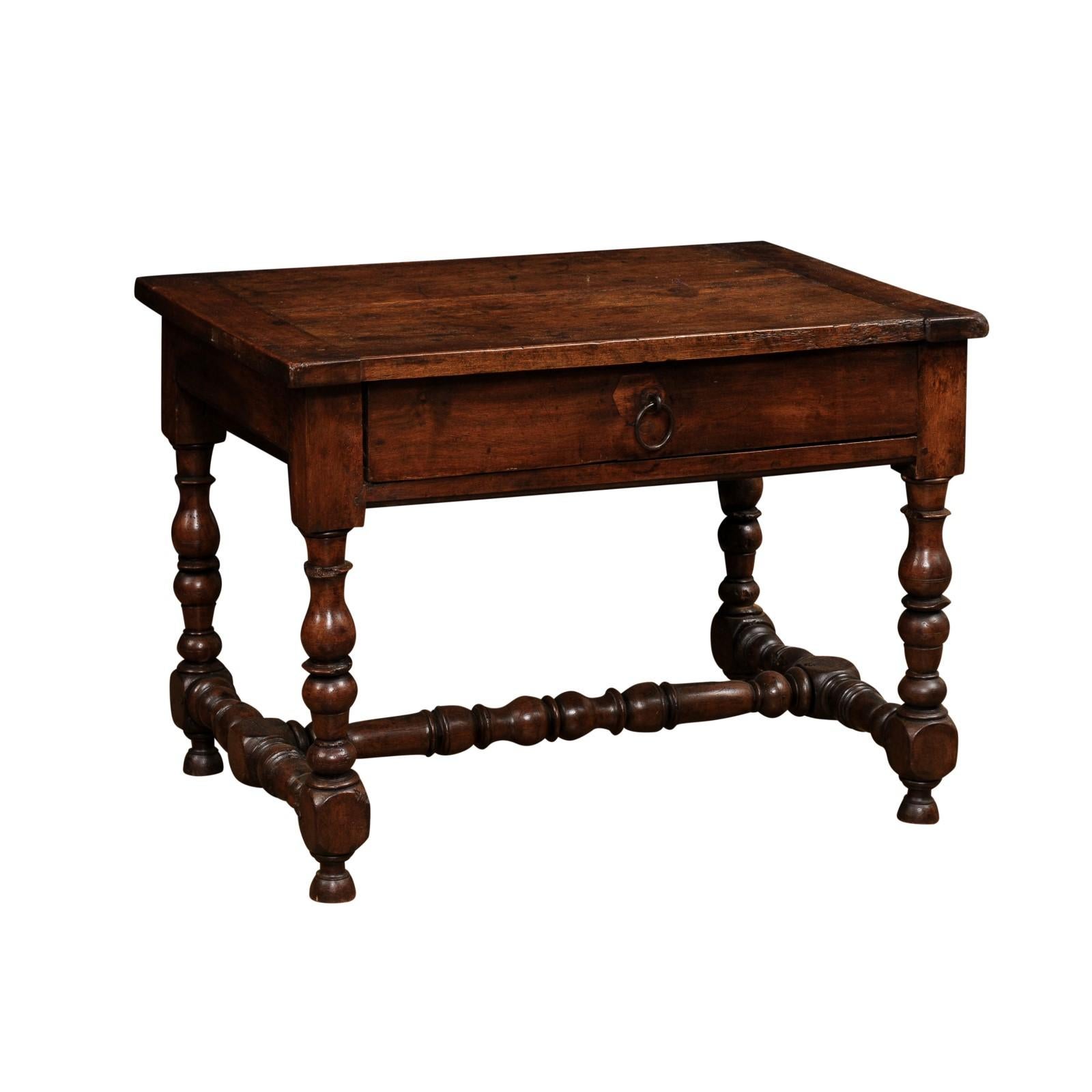 A French Louis XIII period walnut side table from the mid 17th century, with single drawer, turned baluster legs and H-Form stretcher. Created in France during the second quarter of the 17th century, this walnut side table features a rectangular