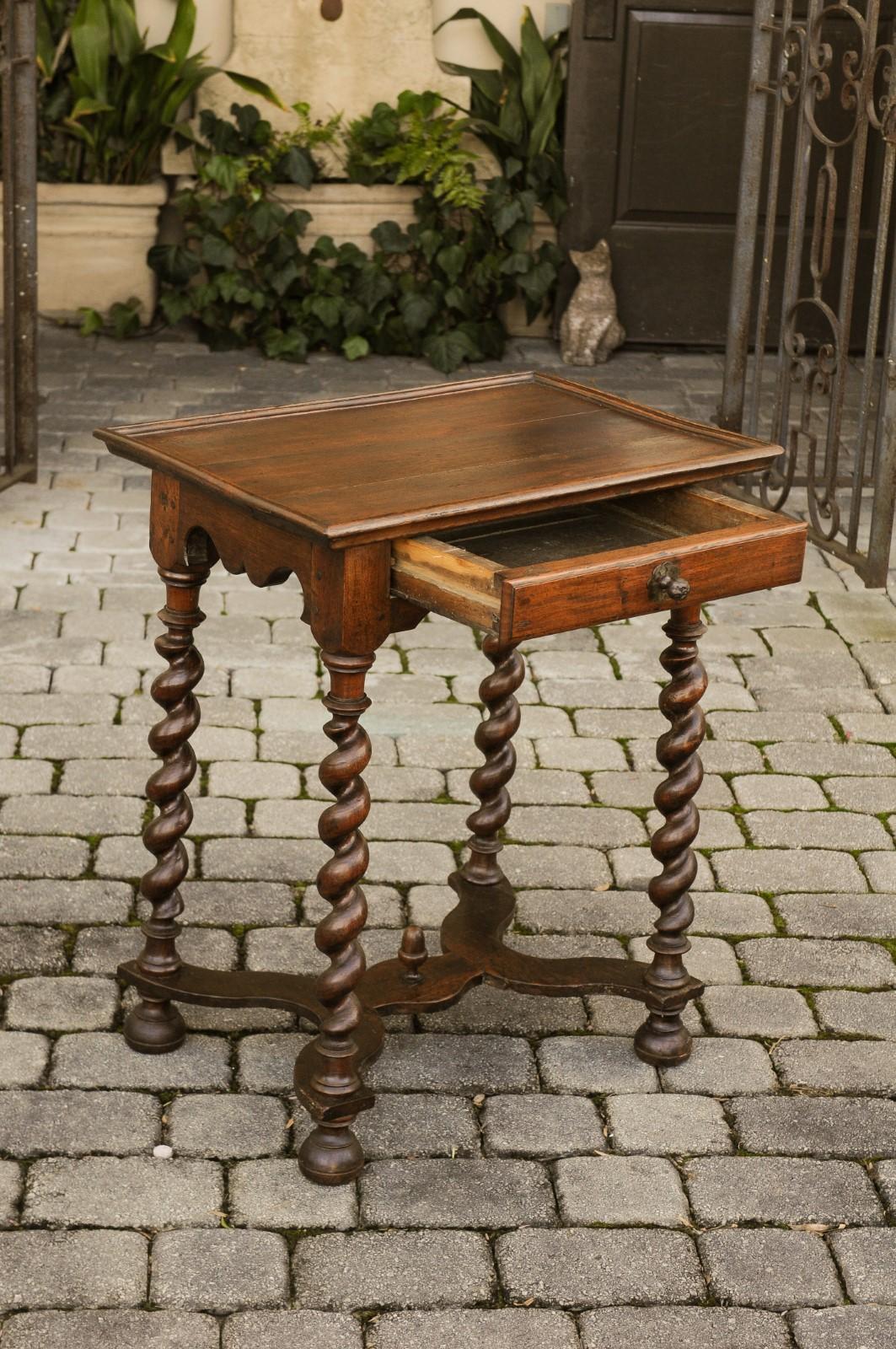 A French Louis XIII style walnut side table from the third quarter of the 19th century, with single drawer, barley twist base and X-form cross stretcher. Born in France at the end of Emperor Napoleon III's reign, this lovely side table features a