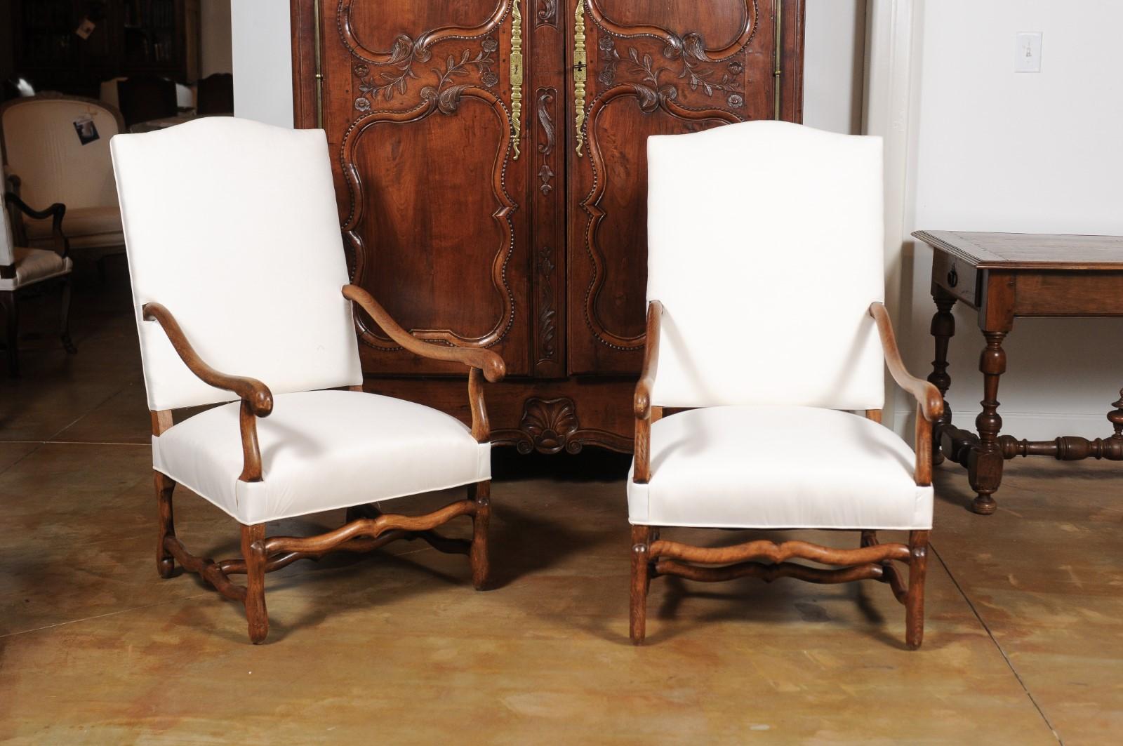 Large French Louis XIII style os de mouton armchairs from the late 19th century with new upholstery, three available priced individually. They are $2,950 each. Created in France during the last quarter of the 19th century, these wooden fauteuils