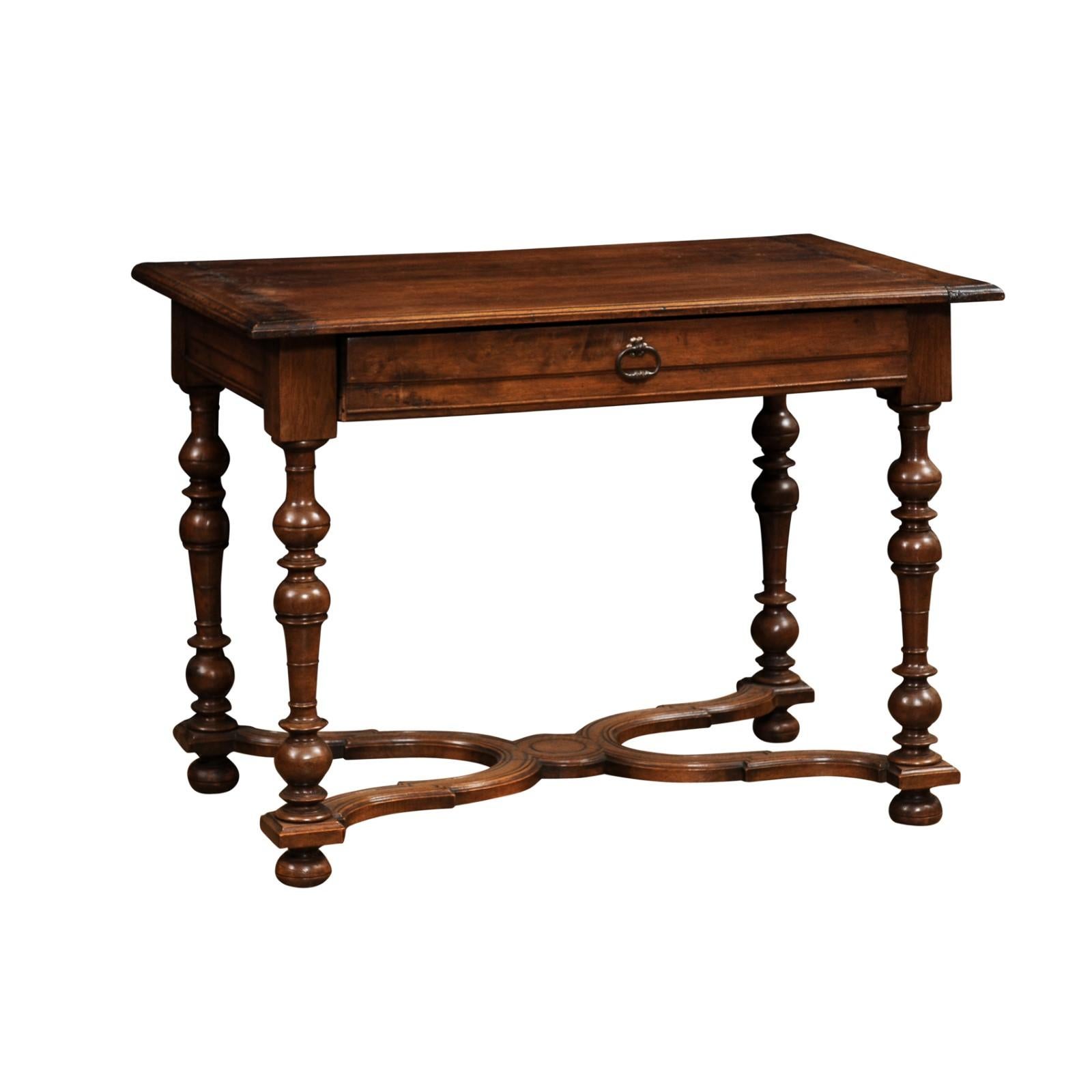 A French Louis XIII style walnut side table from the late 19th century, with baluster legs, single drawer and X-Form cross stretcher. Created in France during the last quarter of the 19th century, this walnut side table showcases the stylistic