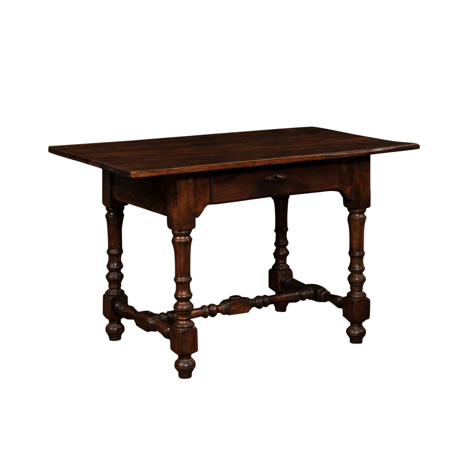 A French Louis XIII style walnut side table from the 19th century, with single drawer, bronze hardware, turned legs and H-Form cross stretcher. Created in France during the 19th century, this walnut table showcases the stylistic characteristics of