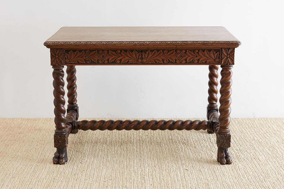 Handsome 19th century library table or writing desk made in Louis XIII taste. Features a beautifully carved case with rosettes supported by thick barley twist legs and stretchers. The legs end with clawed feet and the desk has a large drawer on the
