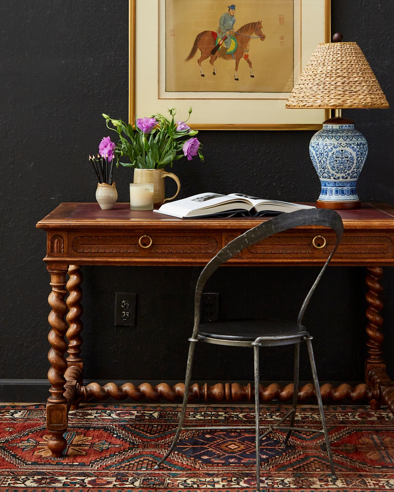 French 19th century oak library table or writing table desk made in the Louis XIII taste. Features barley twist legs and stretchers. Surmounted by an oak case with carved frieze of foliate motifs on all sides centered by a flower in the back.