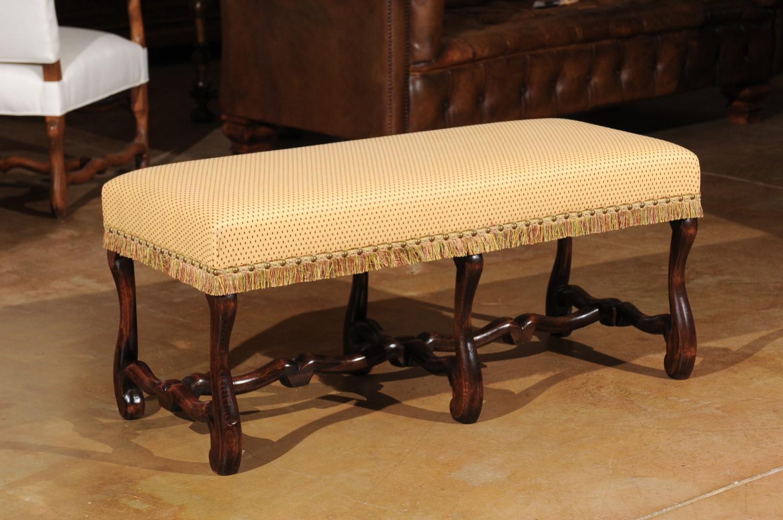 A French Louis XIII style walnut bench from the third quarter of the 19th century, with 'os de mouton' base and upholstery. Born during the reign of Emperor Napoleon III, this exquisite French bench features a rectangular seat covered with a soft