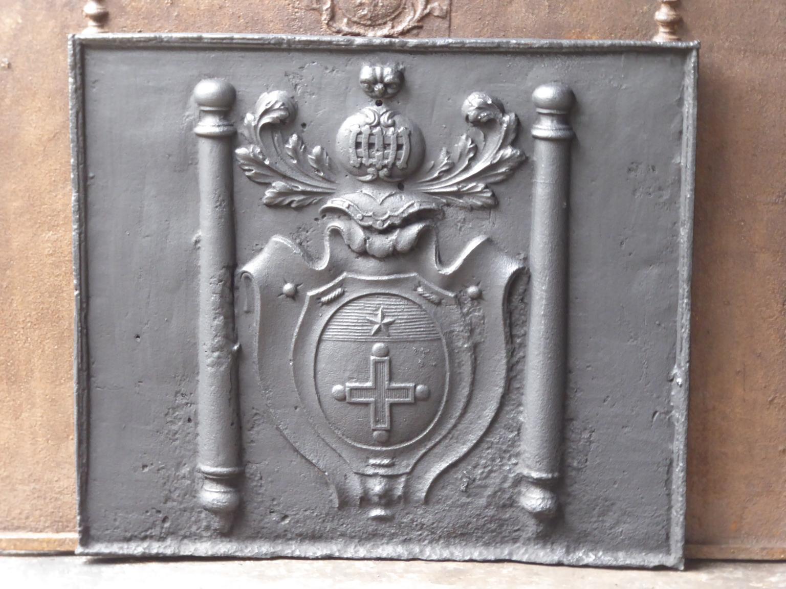 17th-18th century French Louis XIV fireback with an unknown coat of arms and two pillars of Hercules. The pillars of Hercules stand for strength and the unknown. The fireback is made of cast iron and has black / pewter patina. It is in a good