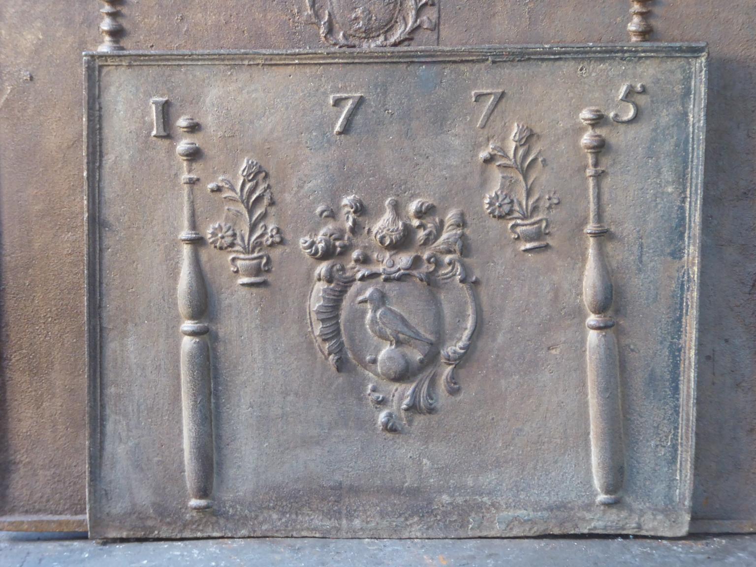 Beautiful 18th century French Louis XIV fireback with an unknown coat of arms. The coat of arms is flanked by two Pillars of Hercules, which symbolize strength and the unknown. The date of production of the fireback, 1775, is also cast in the